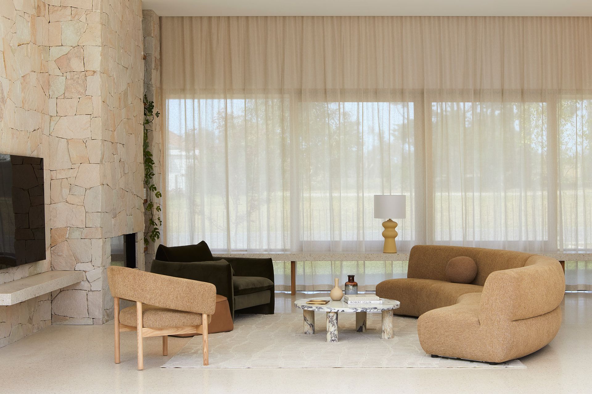 Pictured: Juno Cloud Arc Sofa, Jenson Occasional Chair, Sidney Peak Sofa Chair, Bower River Rug, Amara Round Leg Oval Coffee Table, Lorne Valley Table Lamp