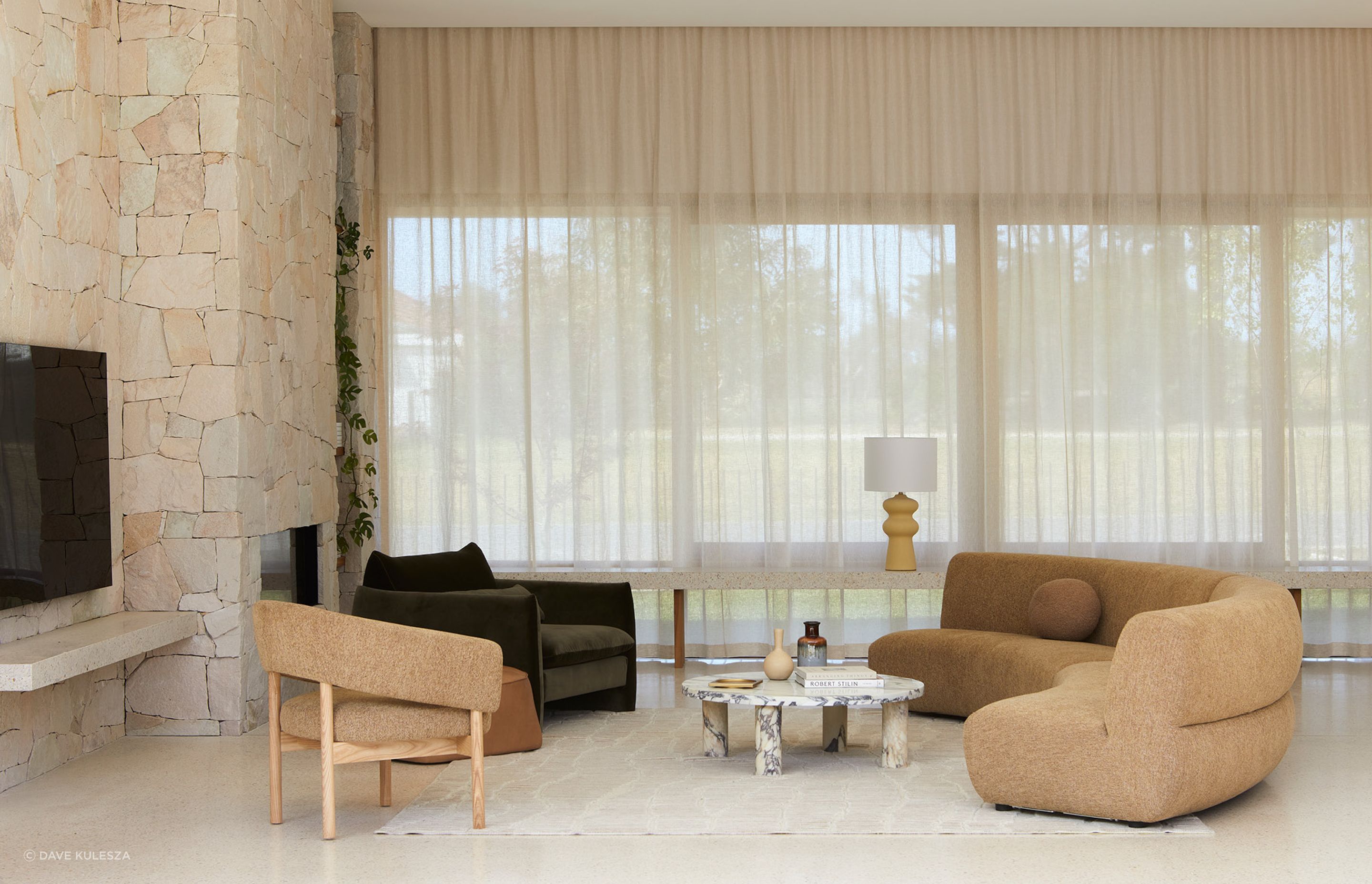 Pictured: Juno Cloud Arc Sofa, Jenson Occasional Chair, Sidney Peak Sofa Chair, Bower River Rug, Amara Round Leg Oval Coffee Table, Lorne Valley Table Lamp