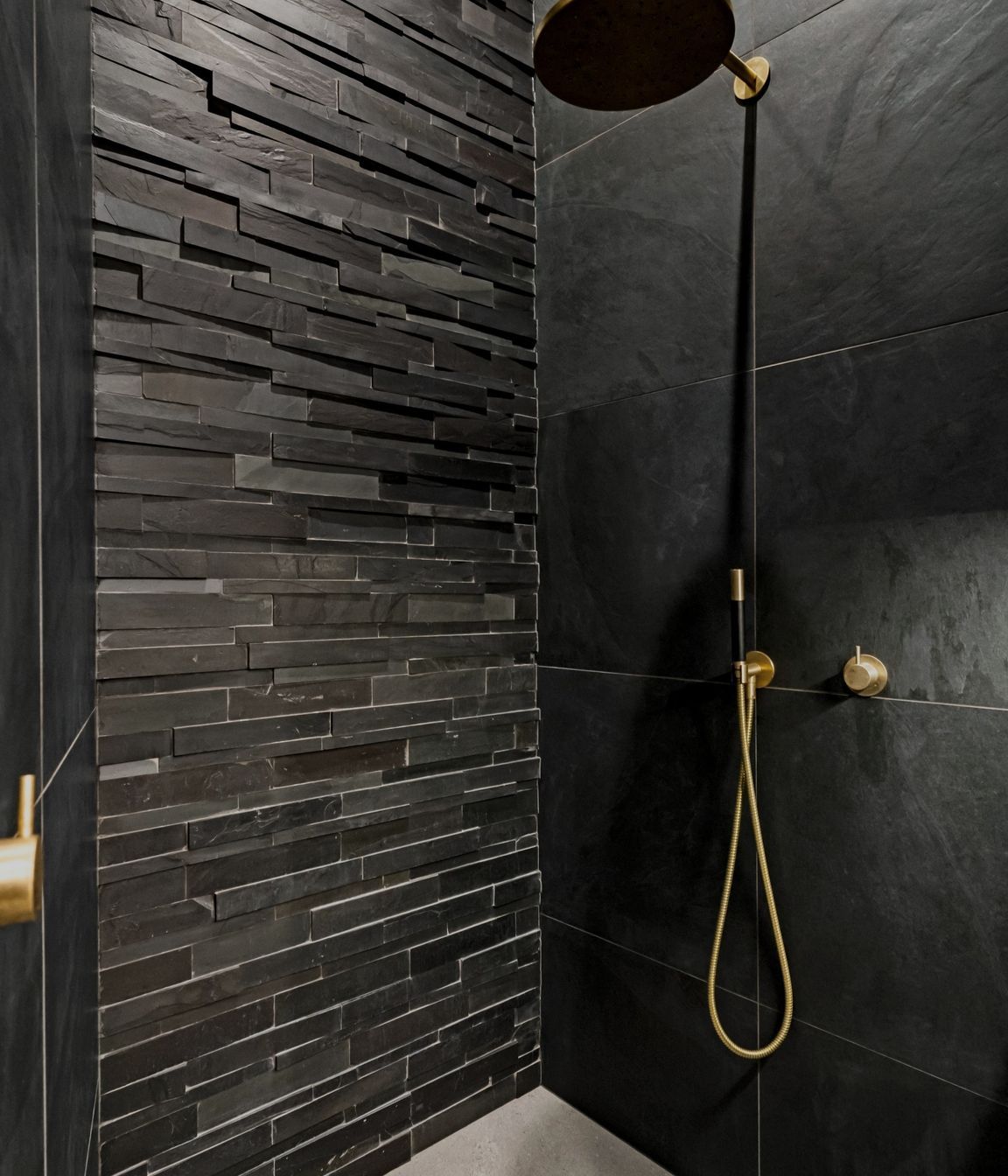 "An exquisite 'Island Stone' feature wall extends dramatically into the unused attic space, achieving an impressive four-meter floor-to-ceiling height. Dimmable recessed ceiling strip lighting enhances the atmosphere, creating a sophisticated and inviting ambiance throughout the area."