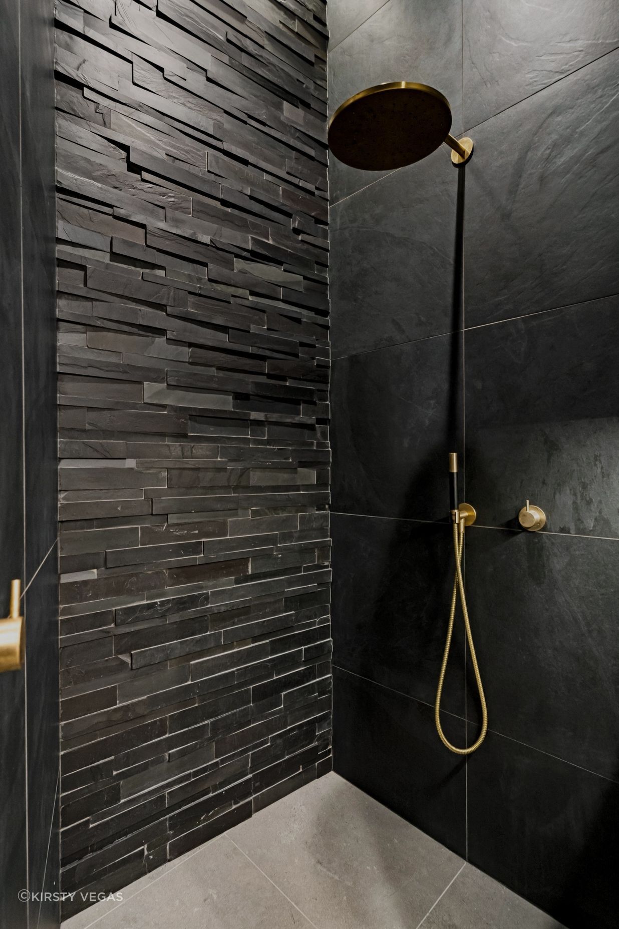 "An exquisite 'Island Stone' feature wall extends dramatically into the unused attic space, achieving an impressive four-meter floor-to-ceiling height. Dimmable recessed ceiling strip lighting enhances the atmosphere, creating a sophisticated and inviting ambiance throughout the area."