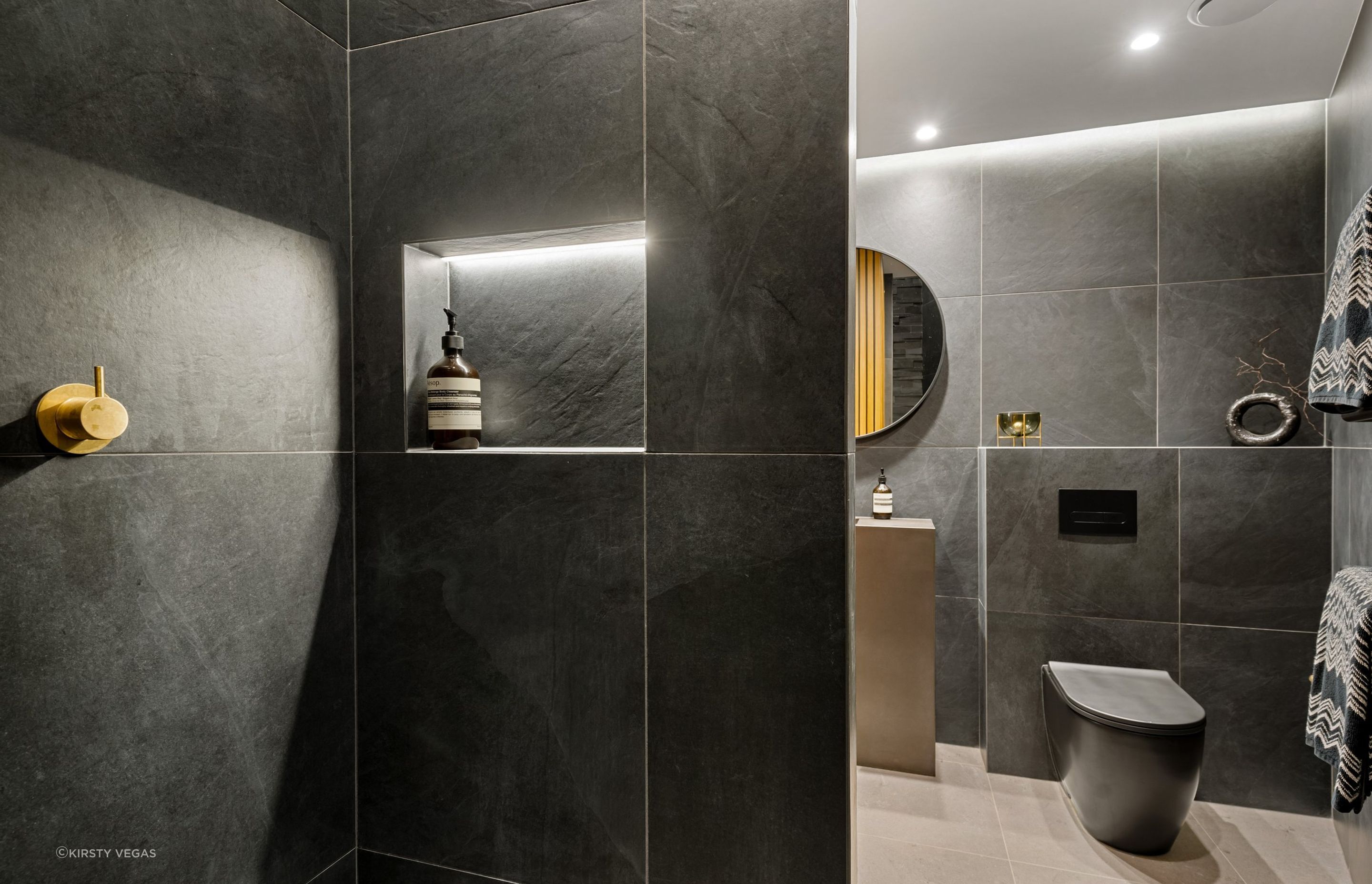 Equipped with both motion-sensor and dimmable recessed lighting, this bathroom strikes the perfect balance between moodiness and practicality, enhancing the overall ambiance and functionality.