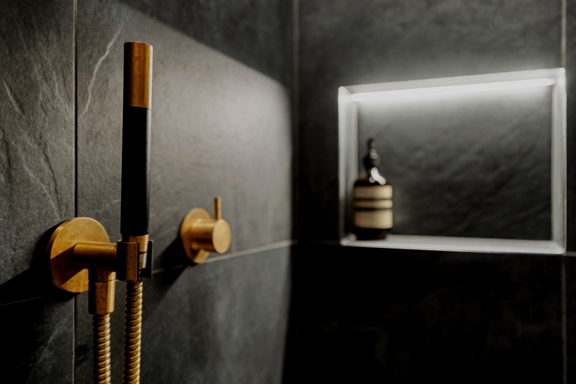 Aged brass Progetto tapware beautifully complements the sleek design of sensored recessed lighting, combining elegance with modern functionality..