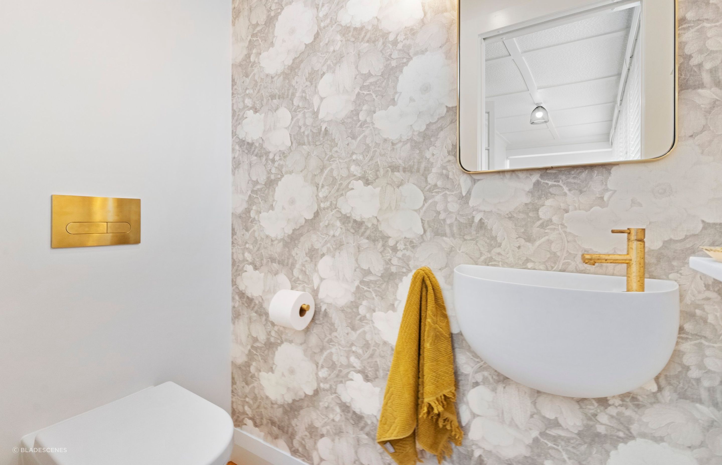 The floral design of this custom linen wallpaper imparts a distinctive and tranquil ambiance to the powder room, transforming it into a serene haven. The delicate patterns and soft colors create a soothing backdrop that enhances the overall aesthetic, inviting relaxation and a sense of peace. This beautiful feature adds character and charm, making the powder room a truly special space where guests can feel at ease.