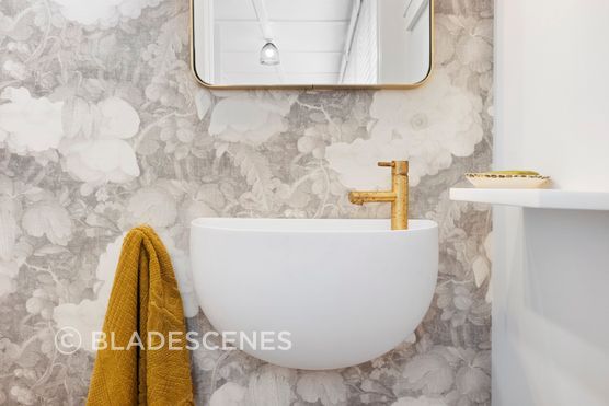 This charming powder room is a delightful blend of elegance and natural beauty, accentuated by the organic brushed brass Progetto tapware that adds a touch of sophistication. The stunning wall-hung Lavamani round basin perfectly complements the space, harmonizing beautifully with the custom linen floral wallpaper. This combination creates a serene and inviting atmosphere, making the powder room not just functional, but also a stylish retreat that reflects refined taste and attention to detail.