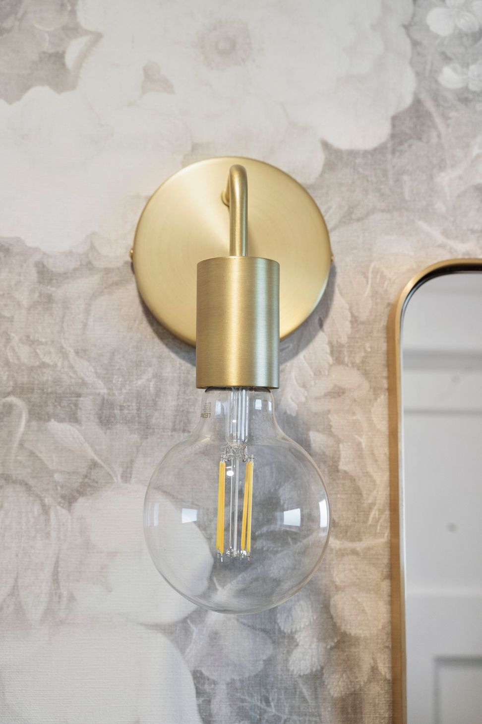 The gentle, curved lines of the brushed brass accents seamlessly blend into the overall design of the space, adding a touch of elegance and sophistication. These soft contours complement the existing elements, creating a harmonious interplay of textures and finishes. The refined brass detailing not only enhances the aesthetic but also invites warmth, making the room feel inviting and beautifully cohesive.