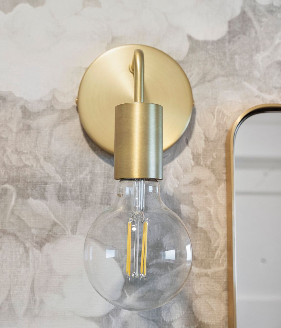 The gentle, curved lines of the brushed brass accents seamlessly blend into the overall design of the space, adding a touch of elegance and sophistication. These soft contours complement the existing elements, creating a harmonious interplay of textures and finishes. The refined brass detailing not only enhances the aesthetic but also invites warmth, making the room feel inviting and beautifully cohesive.
