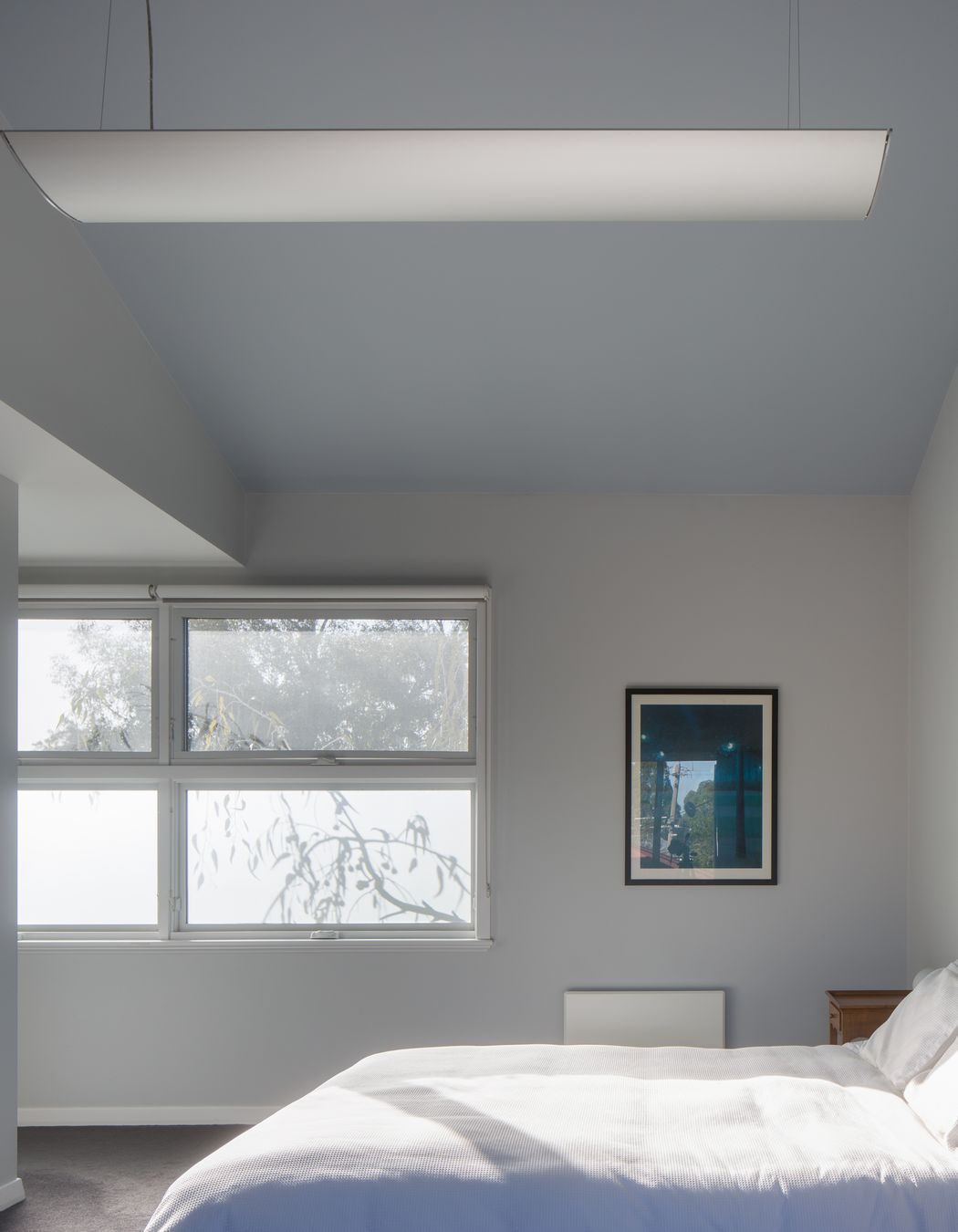 Frosted glass brings in light and shadows from the native gums, while allowing for privacy in the upstairs bedroom.