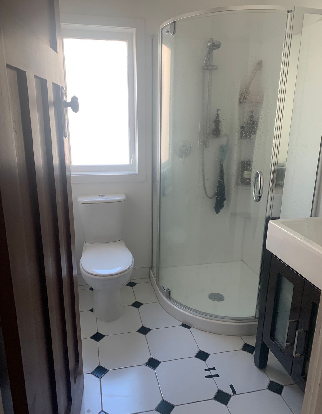 Before the renovation, the main bathroom was noticeably small and had a dated appearance that limited its functionality and aesthetic appeal. The existing layout constrained movement and made it feel even more confined. However, by repositioning the window and extending into the hallway, we created valuable additional space. This strategic alteration allowed for the integration of larger shower and vanity areas, transforming the bathroom into a more comfortable and inviting environment, ready for a modern makeover.