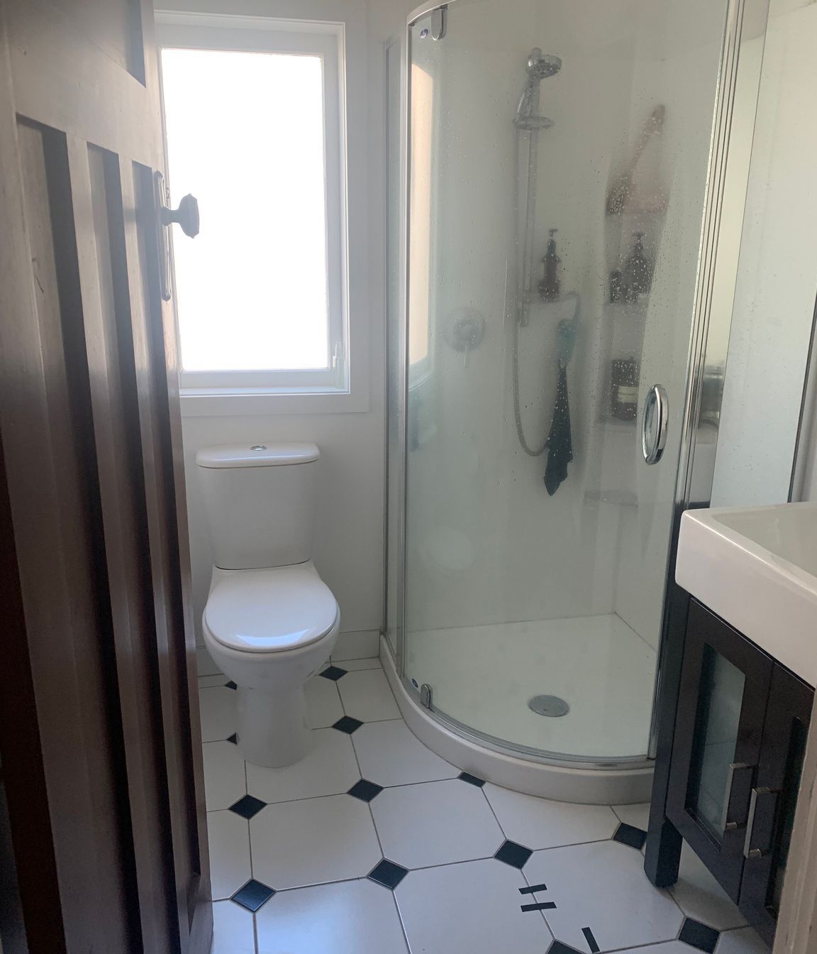 Before the renovation, the main bathroom was noticeably small and had a dated appearance that limited its functionality and aesthetic appeal. The existing layout constrained movement and made it feel even more confined. However, by repositioning the window and extending into the hallway, we created valuable additional space. This strategic alteration allowed for the integration of larger shower and vanity areas, transforming the bathroom into a more comfortable and inviting environment, ready for a modern makeover.