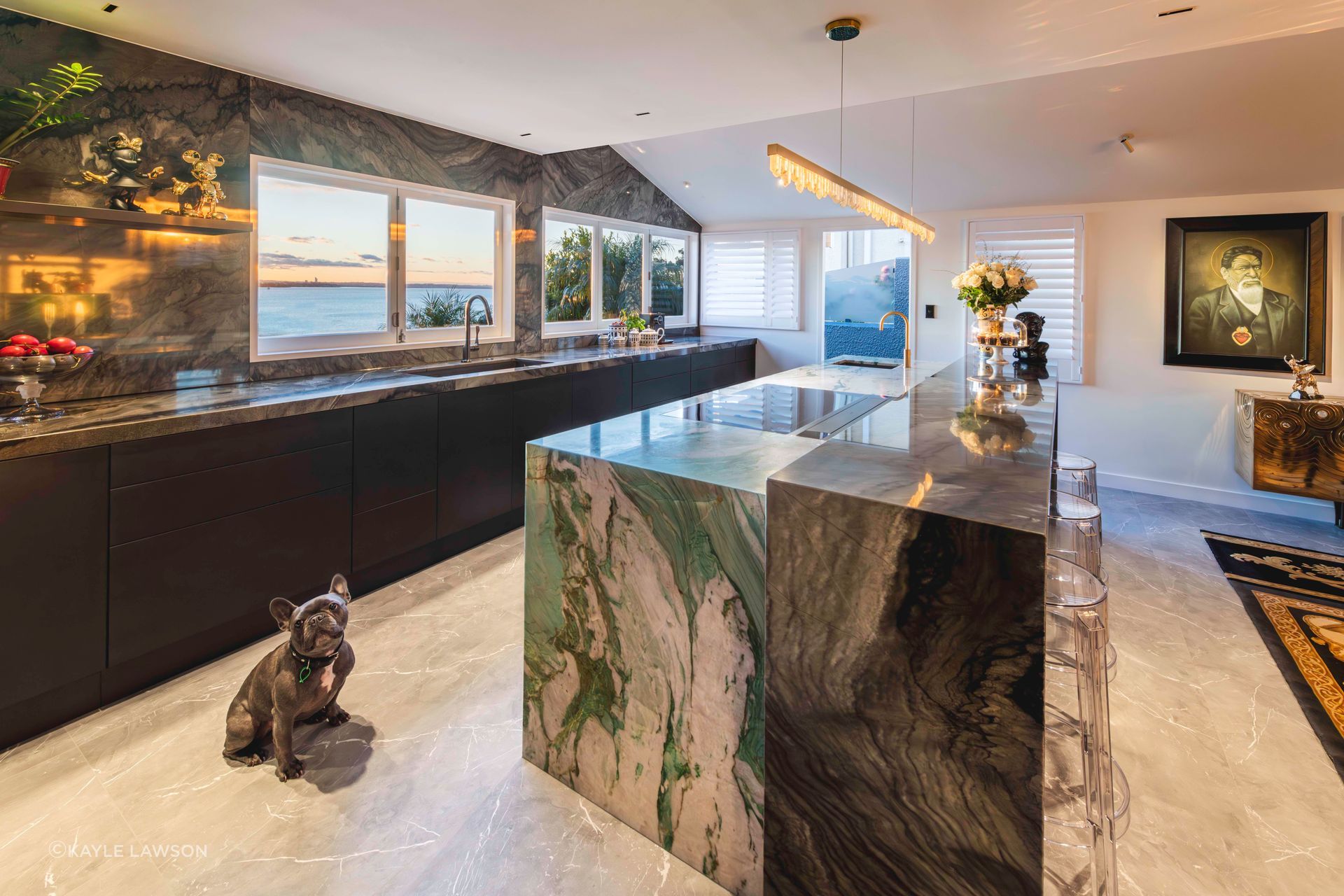 The design evolved around the discovery of a spectacular statement quartzite stone, an art piece in its own right. It features brushstrokes of jade green veining and shimmering golden highlights on a chalky crystalline bed.