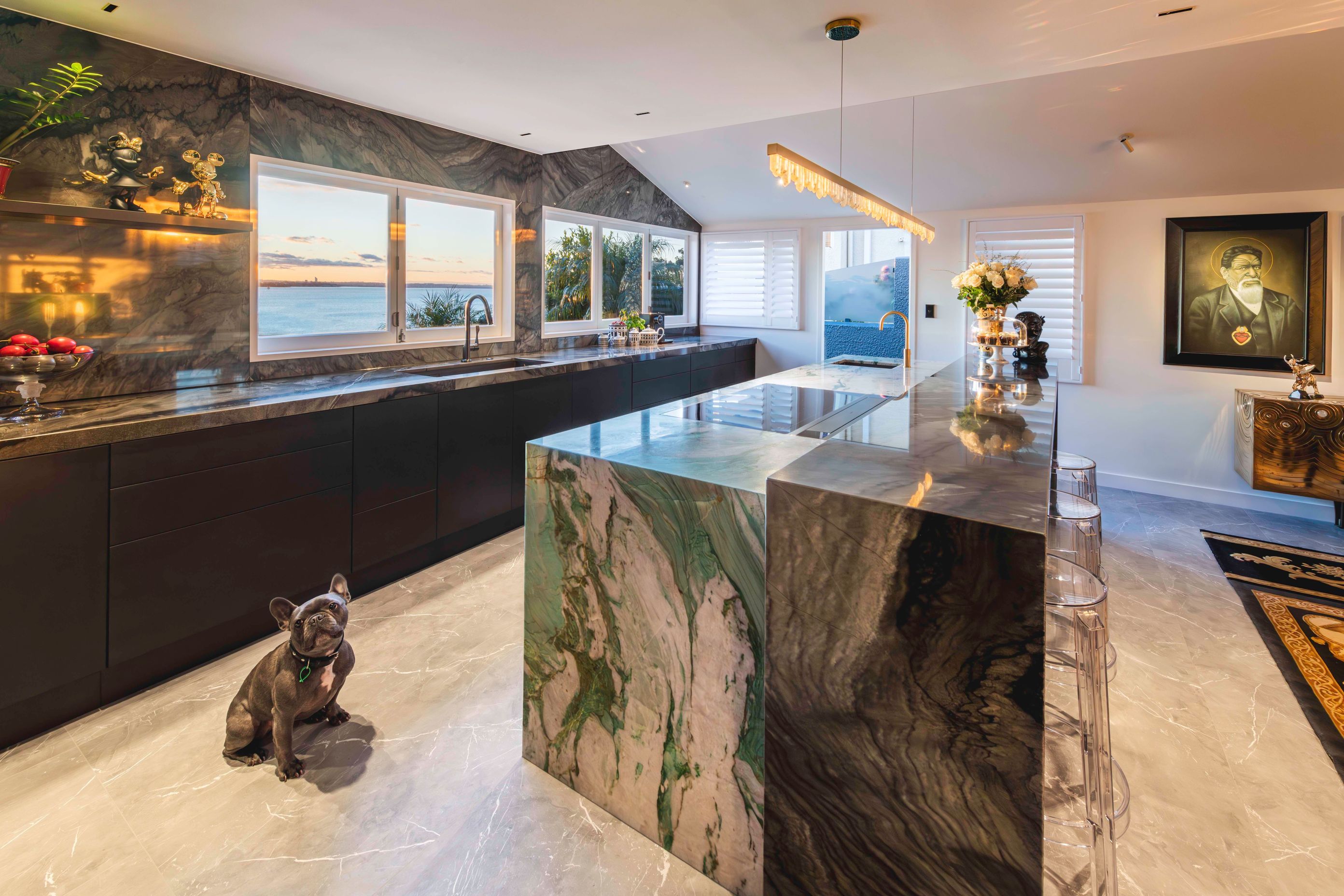 The design evolved around the discovery of a spectacular statement quartzite stone, an art piece in its own right. It features brushstrokes of jade green veining and shimmering golden highlights on a chalky crystalline bed.