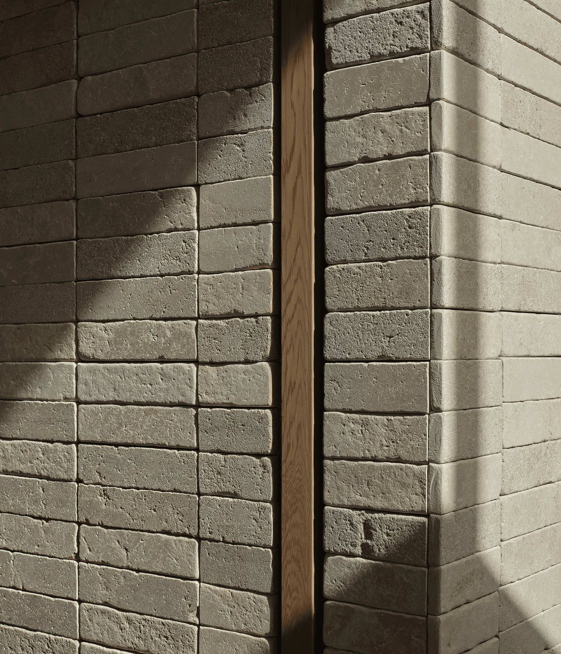 Creamy Pendell batons clad interior and exterior walls to provide linear contrast and form two feature chimney walls, uniting the home with visually rich tactility. The small format limestone was chosen for its supple texture, smooth finish and dimensional accuracy.
