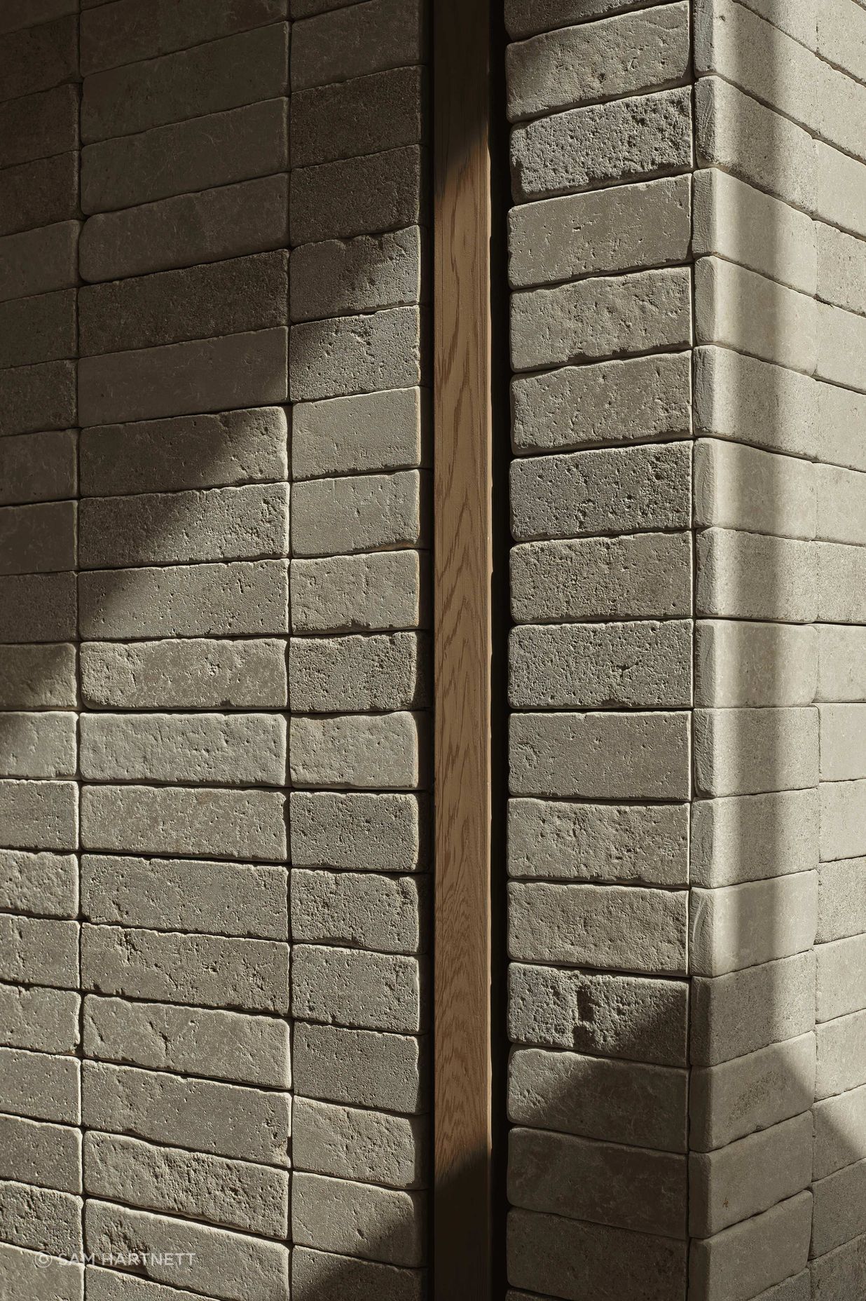 Creamy Pendell batons clad interior and exterior walls to provide linear contrast and form two feature chimney walls, uniting the home with visually rich tactility. The small format limestone was chosen for its supple texture, smooth finish and dimensional accuracy.