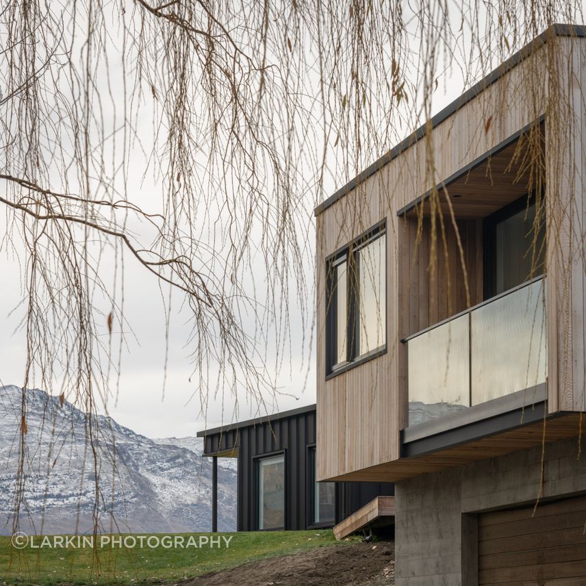 Metal tray cladding contrasts with the earthier, natural tones of cedar and board-finished concrete