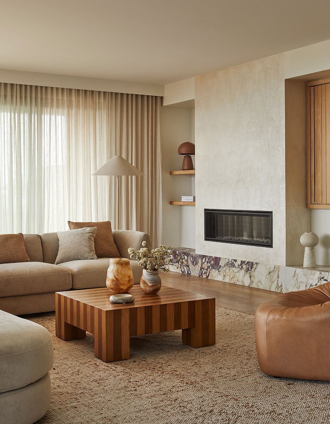 Pictured: Natadora Arbor Sofa Chair, Reese Square Coffee Table, Hanson Spire Vessel, Rufus Indra Shallow Bowl, Boden Perry Vase, Easton Shelter Floor Lamp, Easton Arch Table Lamp, Madrid Modular Sofa