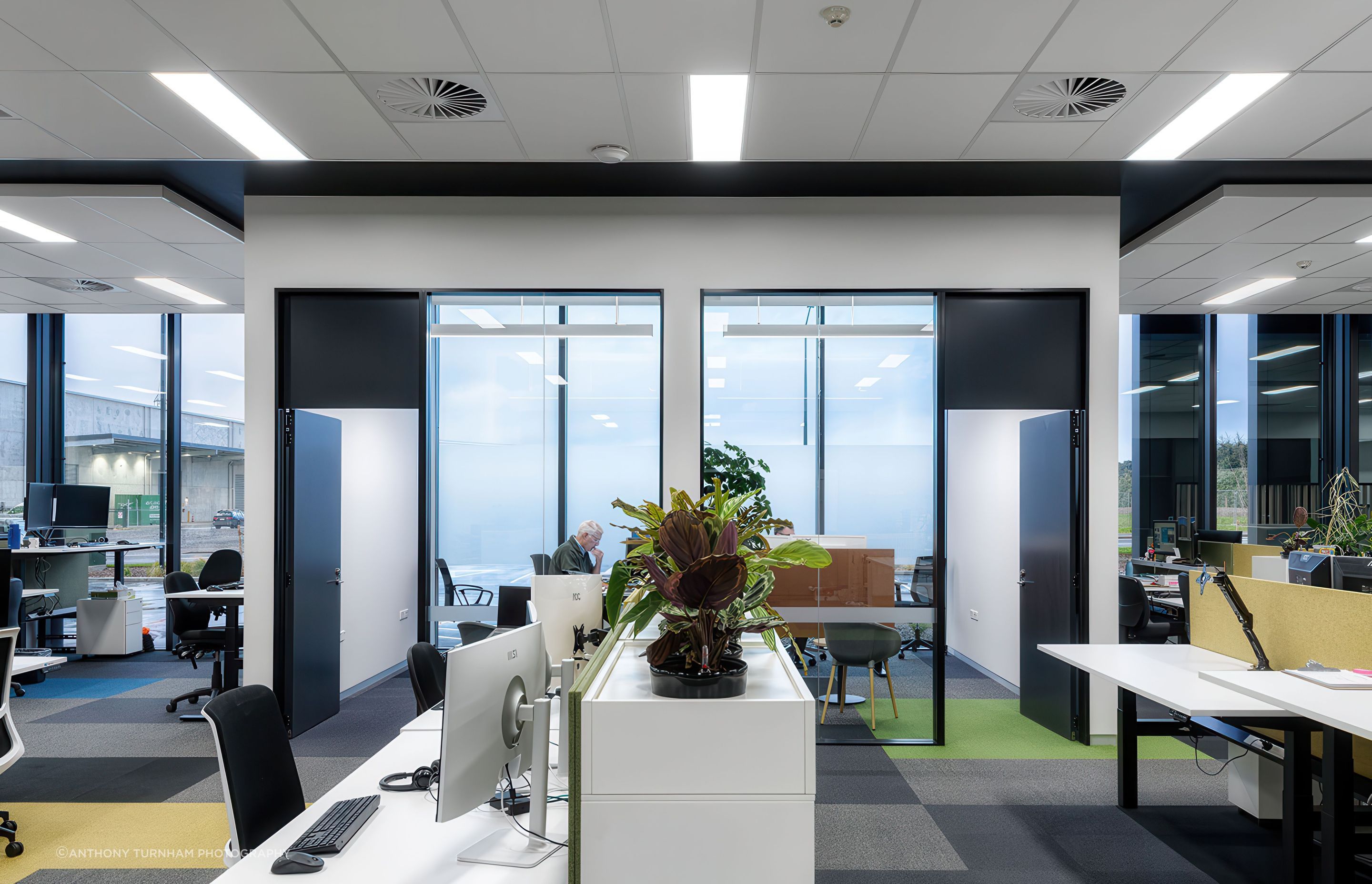 The panel lighting was primarily utilised in the two large, shared office spaces to provide an even and consistent light throughout the whole space.

The cafeteria featured black powder-coated Highline 05 luminaires included as part of the recessed black ceiling sections.  In consideration for the Christchurch location, rod suspensions were used as the main suspension type, however several white luminaires were wall mounted over the sink &amp; mirror areas in the bathrooms.