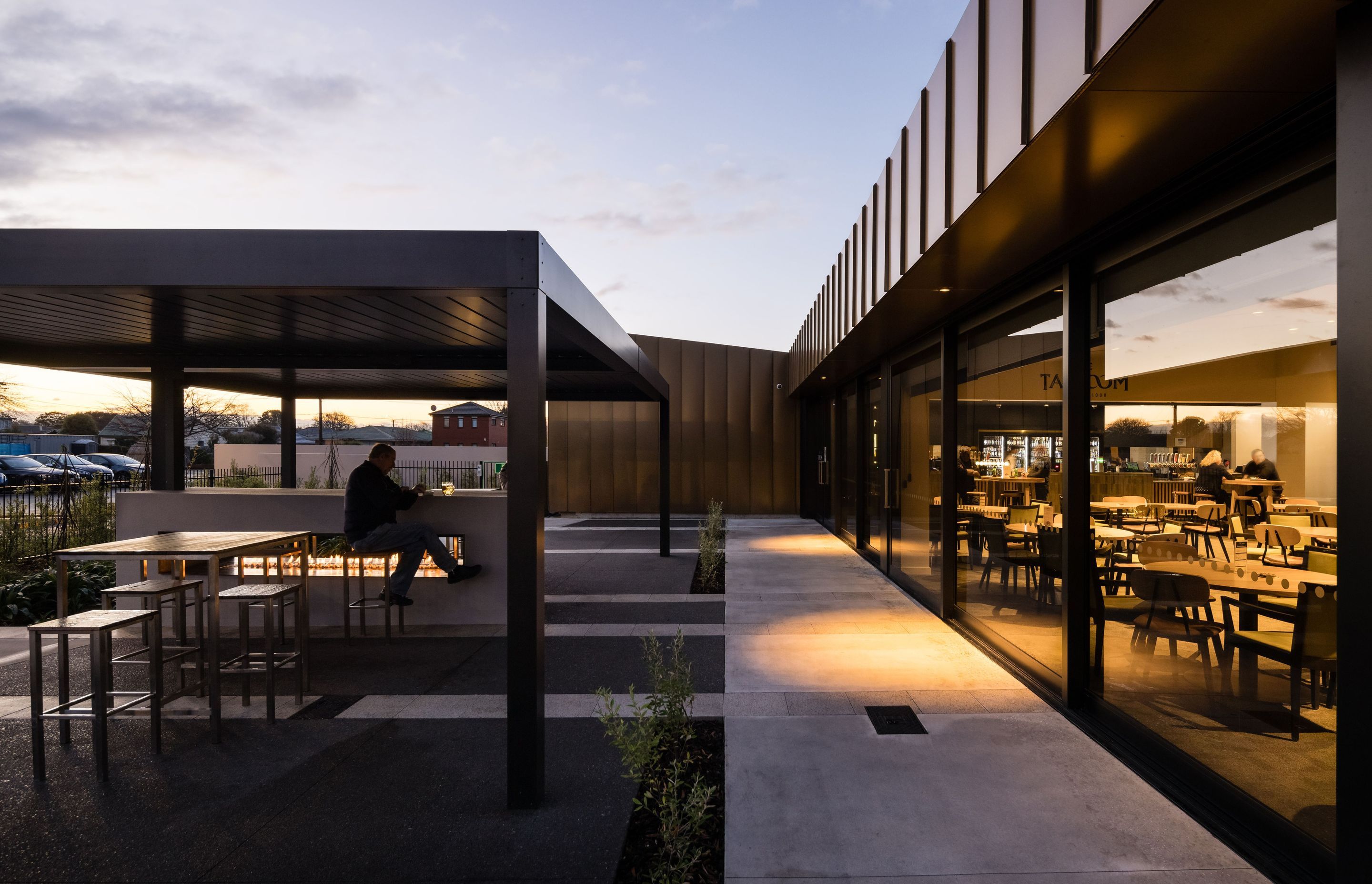 An operable louvre roof and outdoor fireplace mean the terrace is an inviting space that can be used year-round. Photography by Clinton Lloyd.