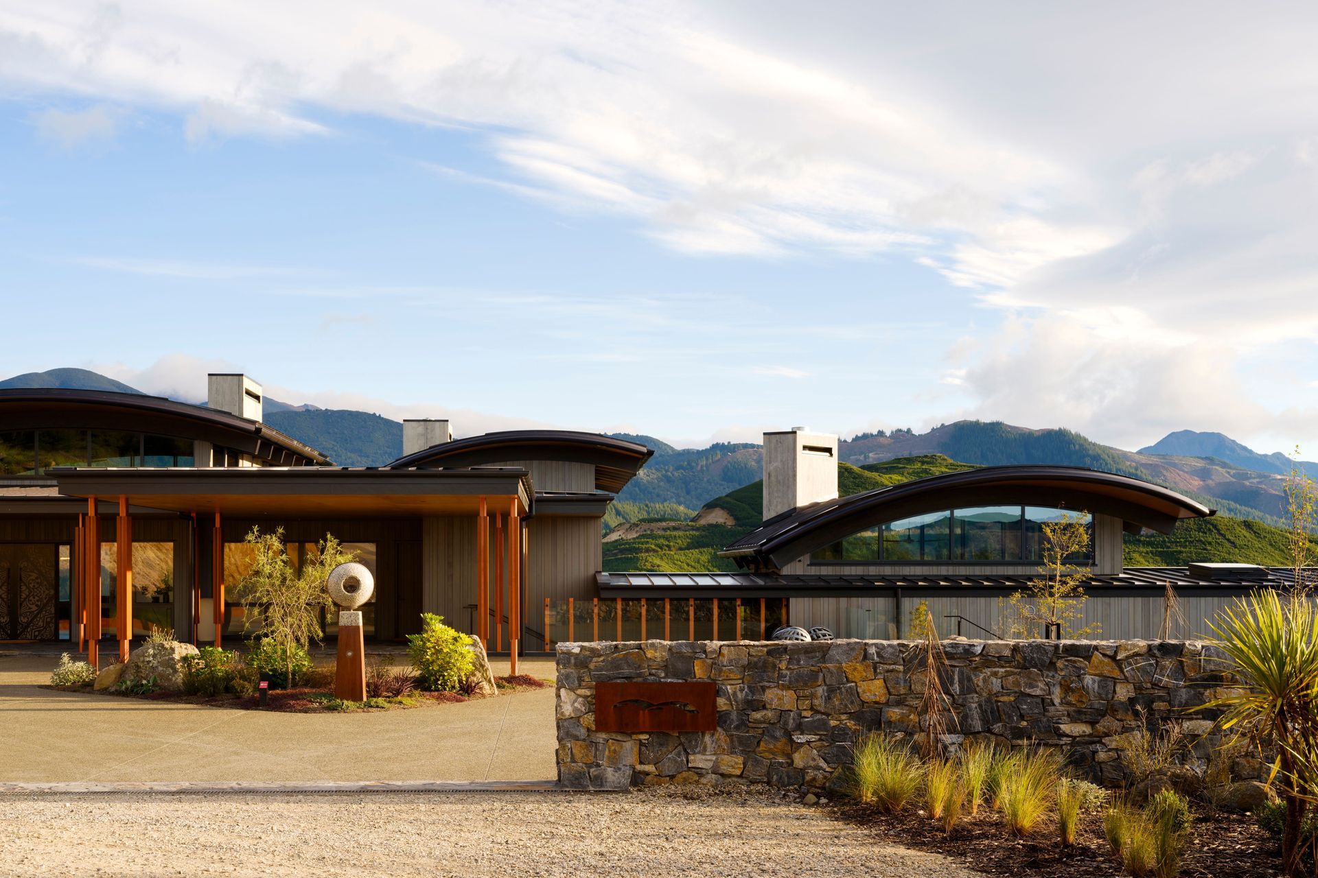 The exterior material palette comprises stone, gravel, concrete, hardwood decking and large-format pavers to lend the project a sense of being remnant with the site.