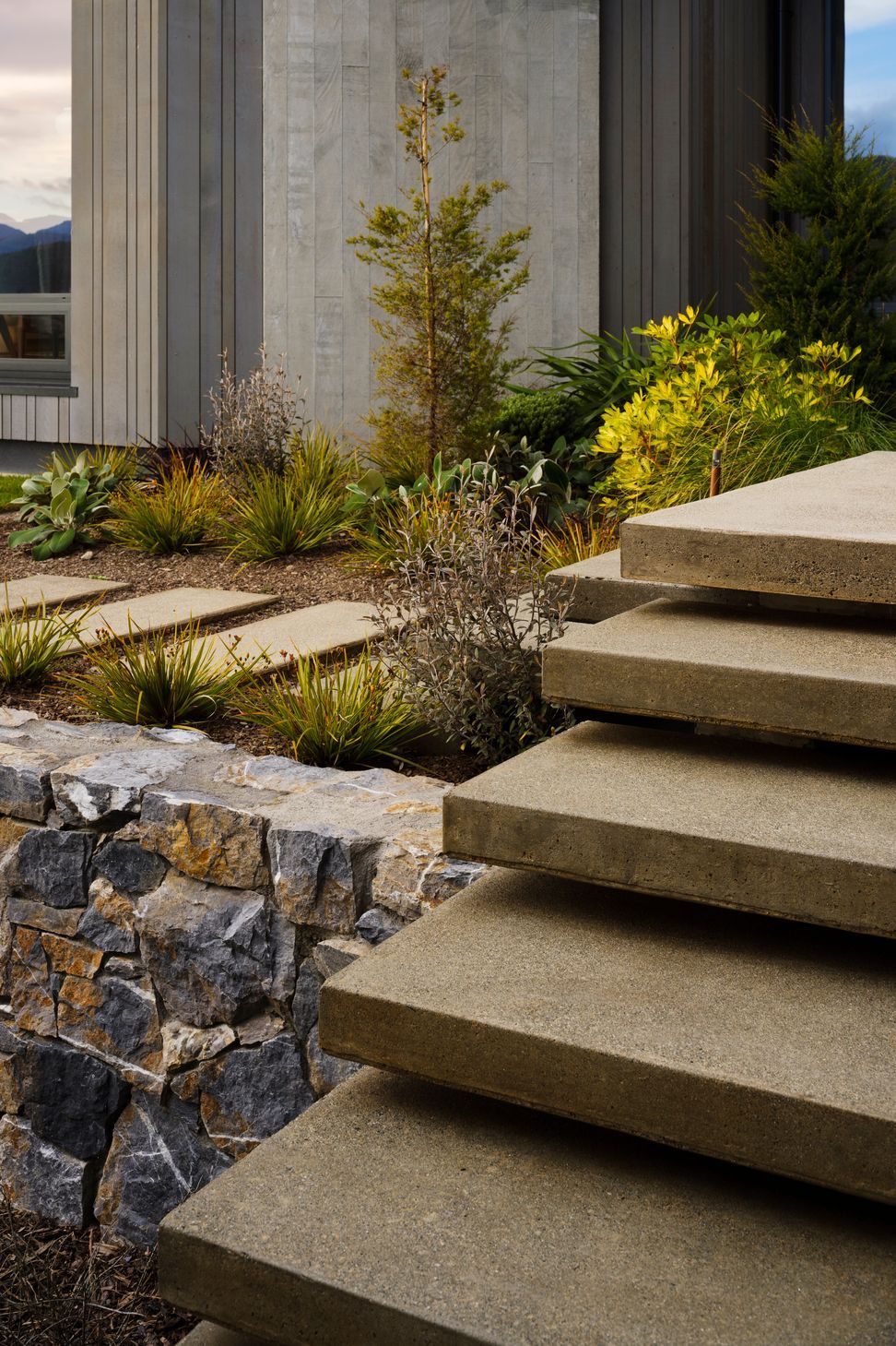 The landscaped terraces, with their rock faces spilling up and around the building, create a series of big gestures that impart a sense of the landscape merging into the environment.