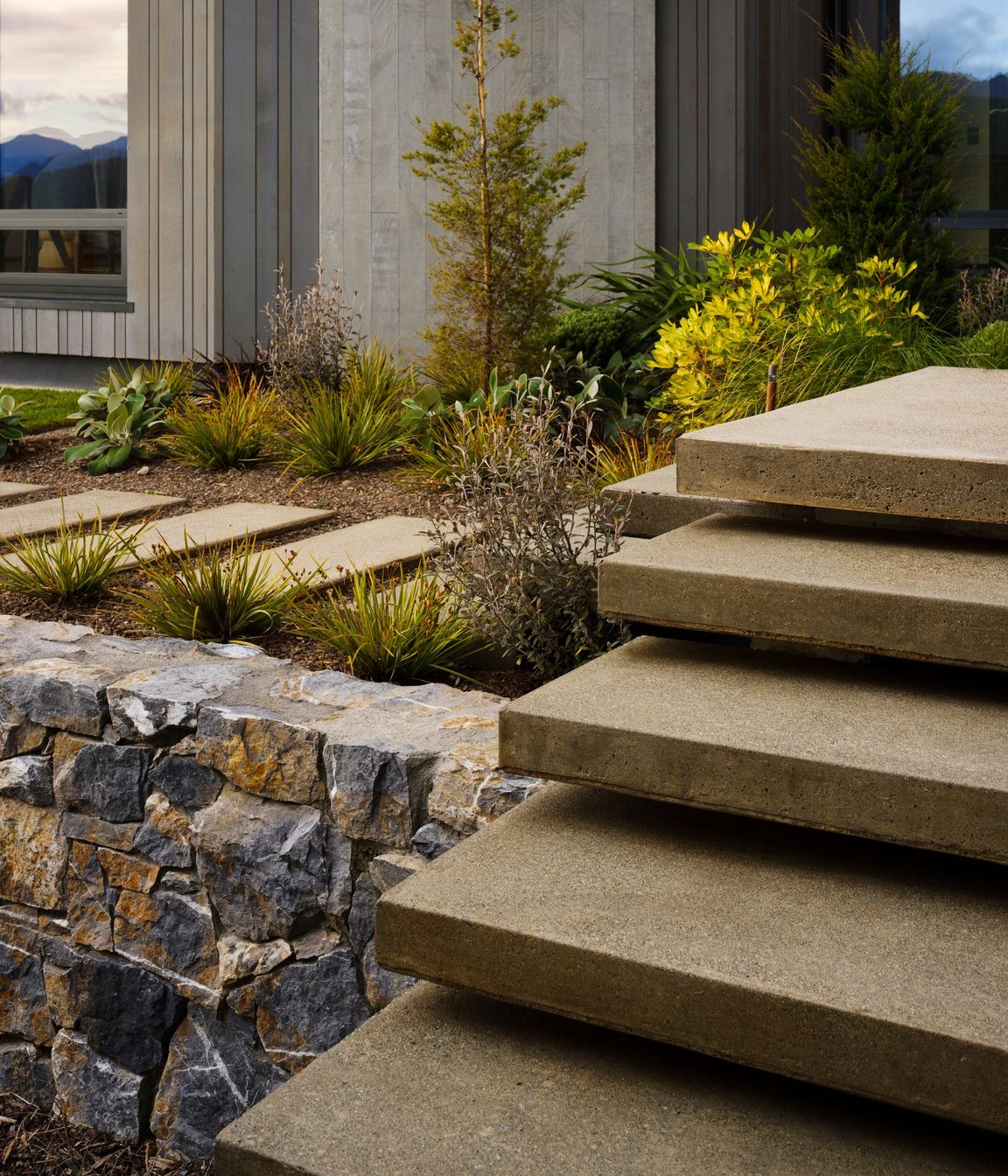 The landscaped terraces, with their rock faces spilling up and around the building, create a series of big gestures that impart a sense of the landscape merging into the environment.
