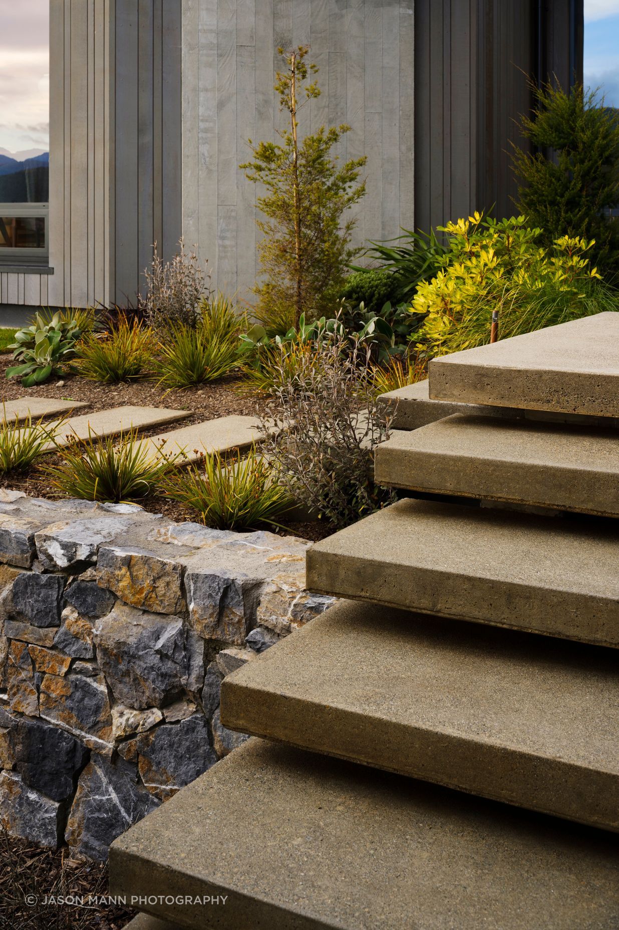 The landscaped terraces, with their rock faces spilling up and around the building, create a series of big gestures that impart a sense of the landscape merging into the environment.