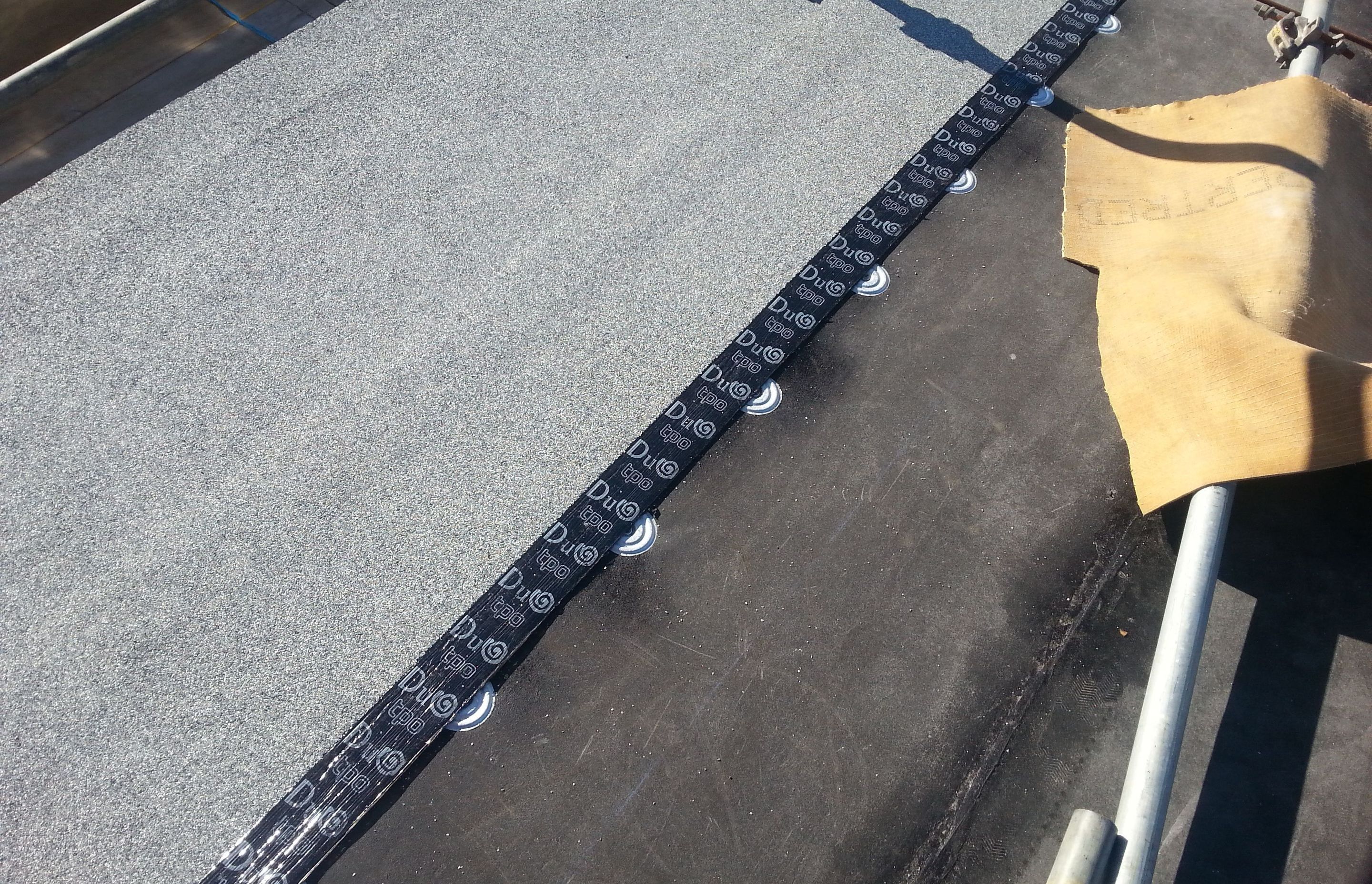 Installation of Duotherm Warm Roof - waterproofing membrane over thermal insulation