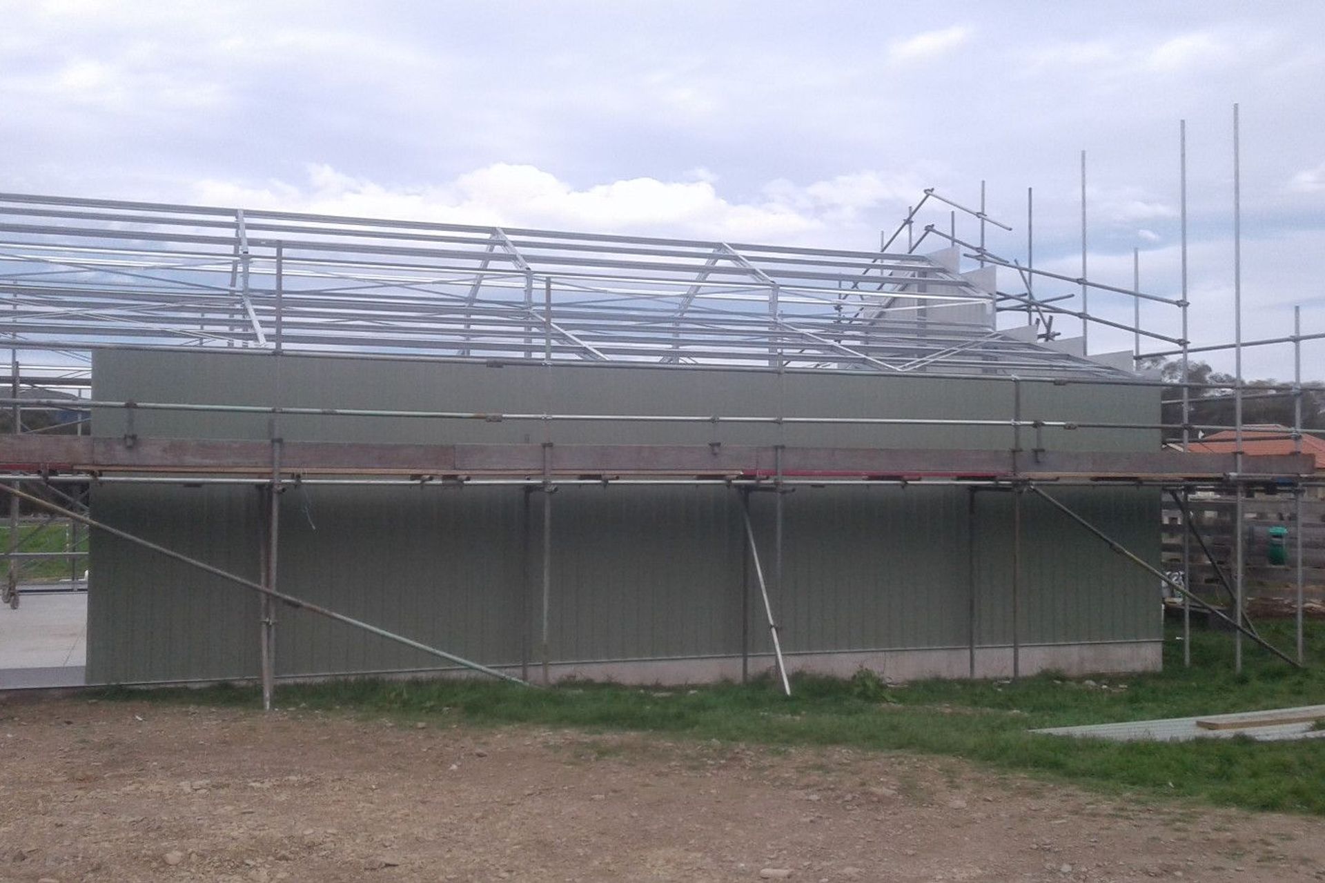 Close up of cladding being erected on one of the sides cont-