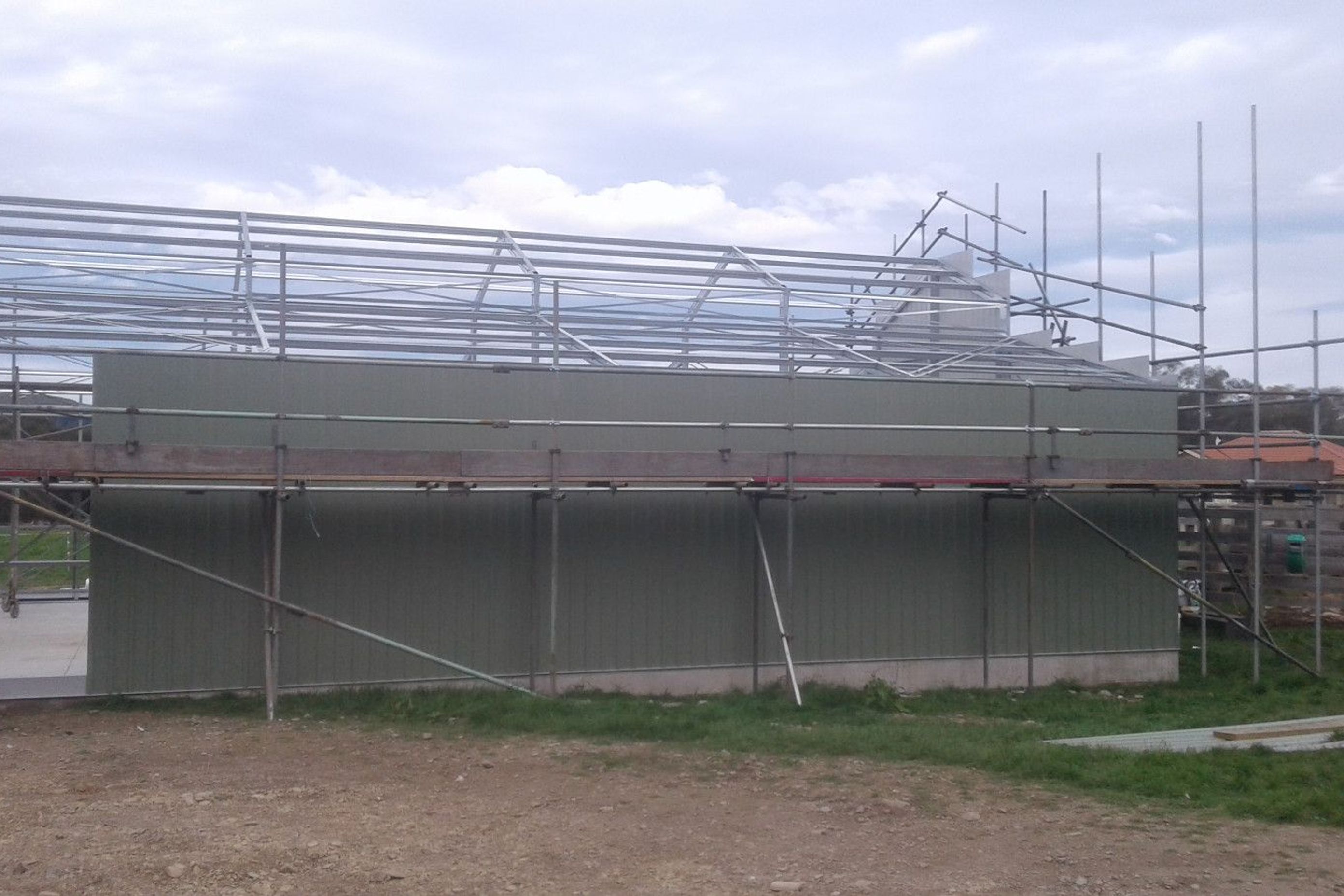 Close up of cladding being erected on one of the sides cont-