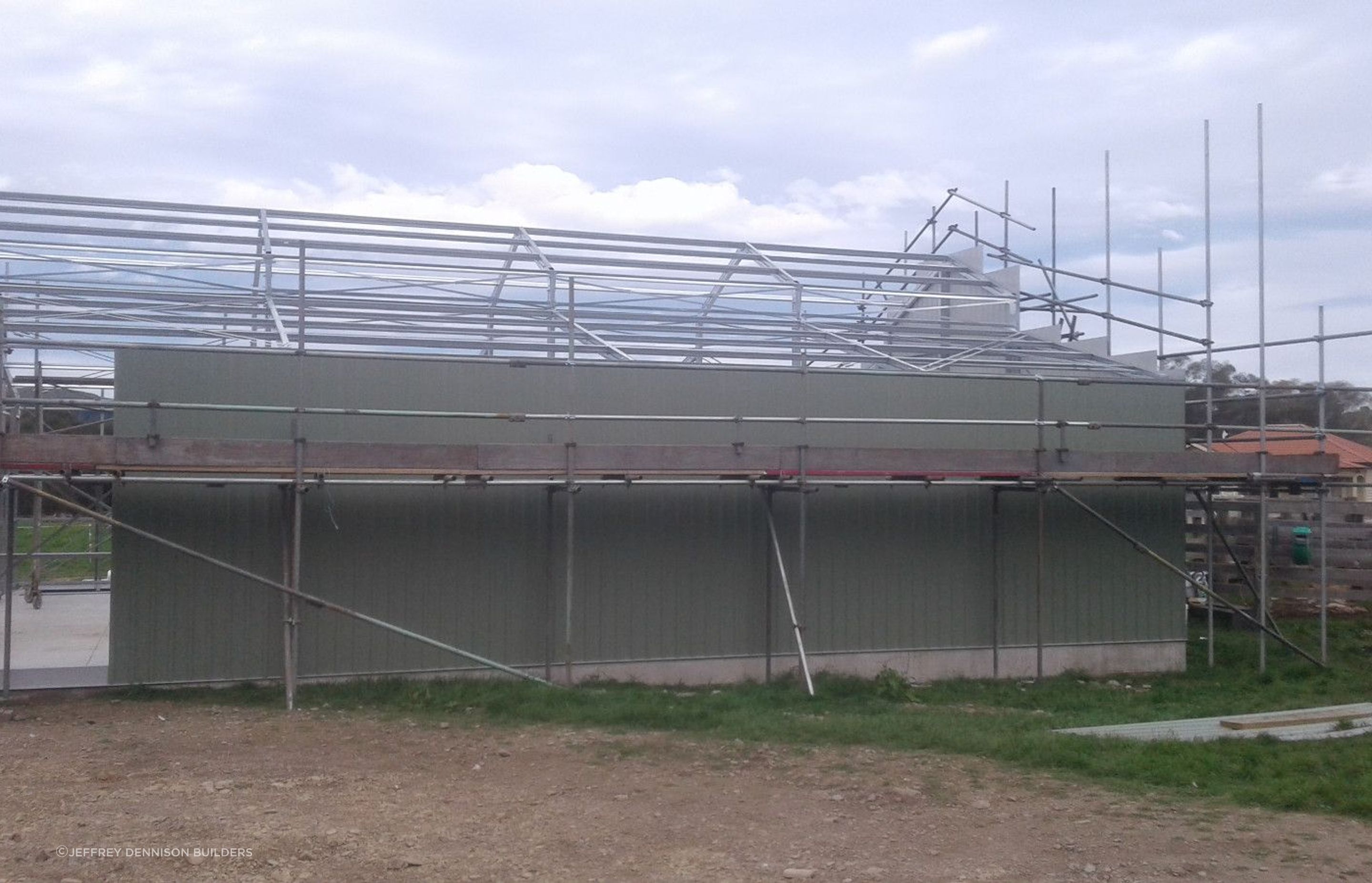 Close up of cladding being erected on one of the sides cont-