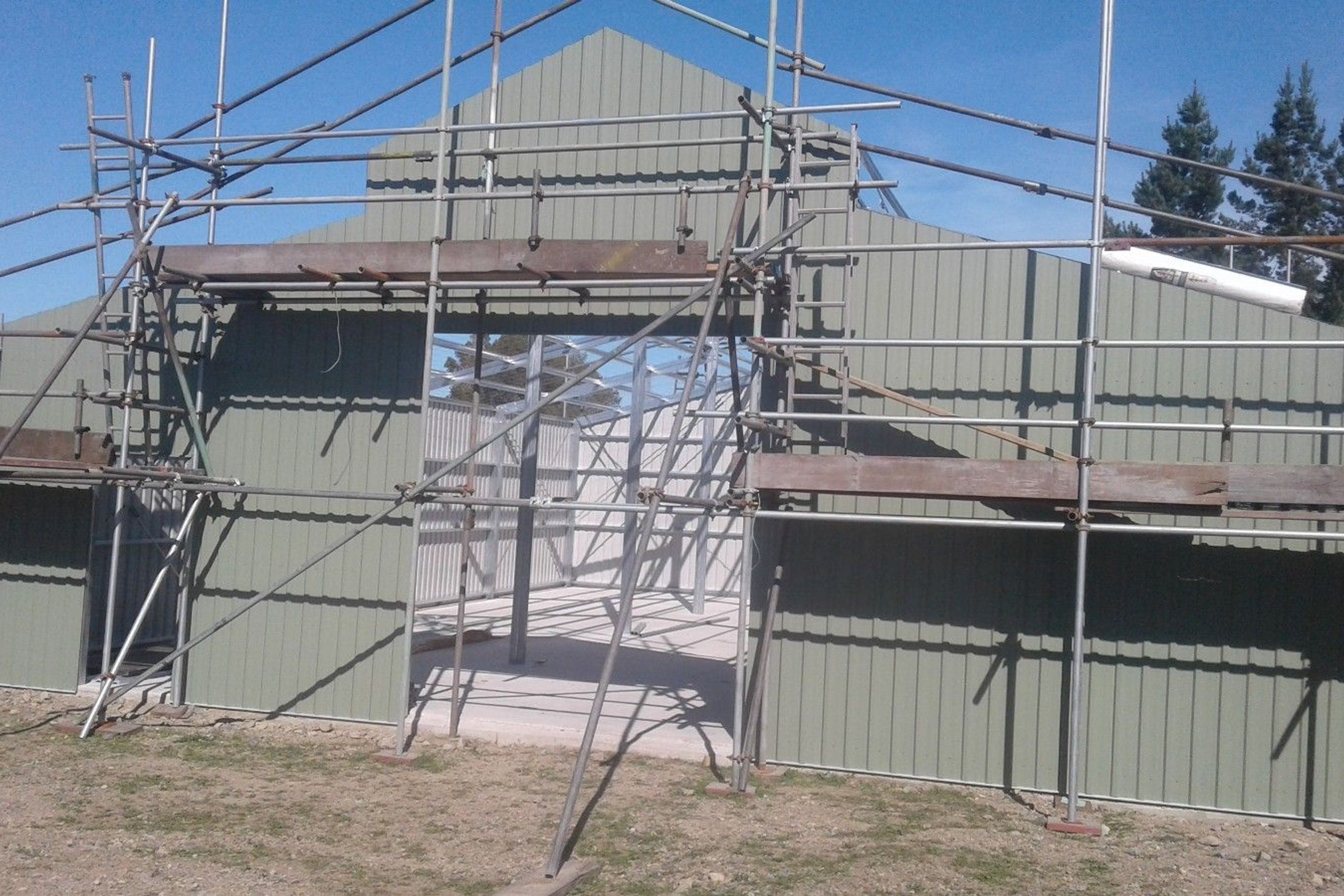 Cladding on the front of the three bay shed being erected