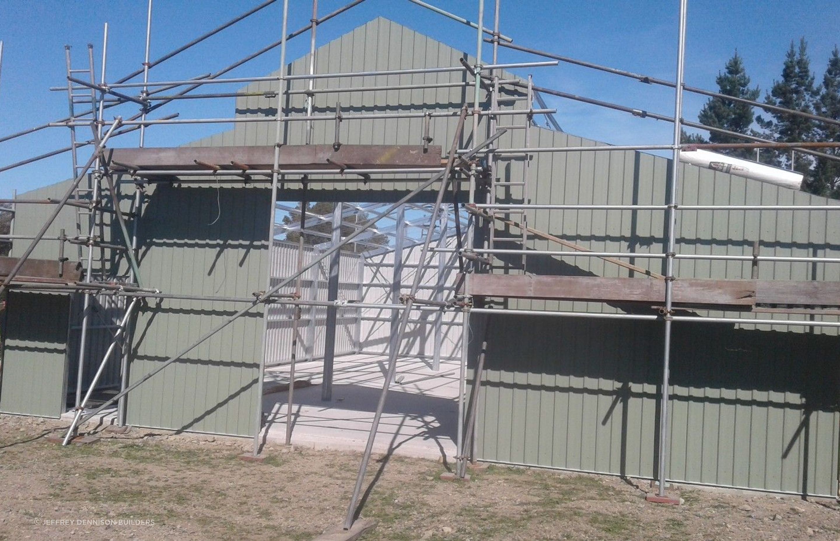 Cladding on the front of the three bay shed being erected
