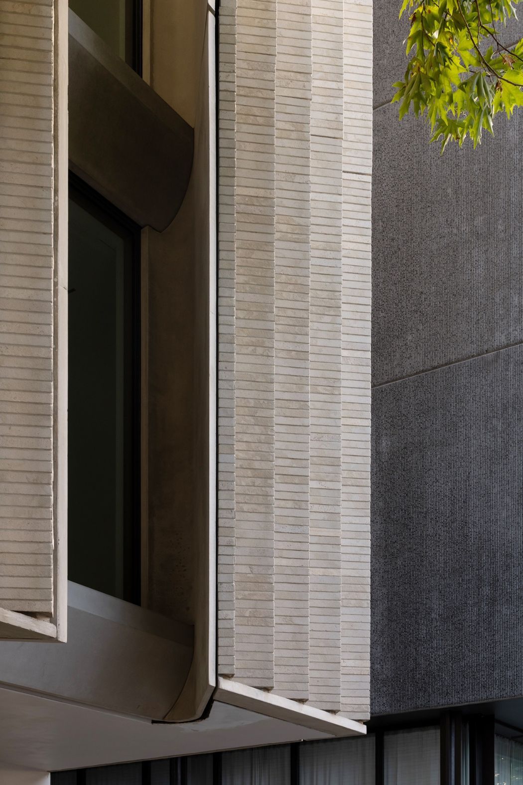 A-close-view-of-the-facade-reveals-the-depth-of-the-splayed-window-bays-where-natural-limestone-bricks-create-shadow-texture-and-a-sense-of-solidity-Photography-Jono-Parke.jpg