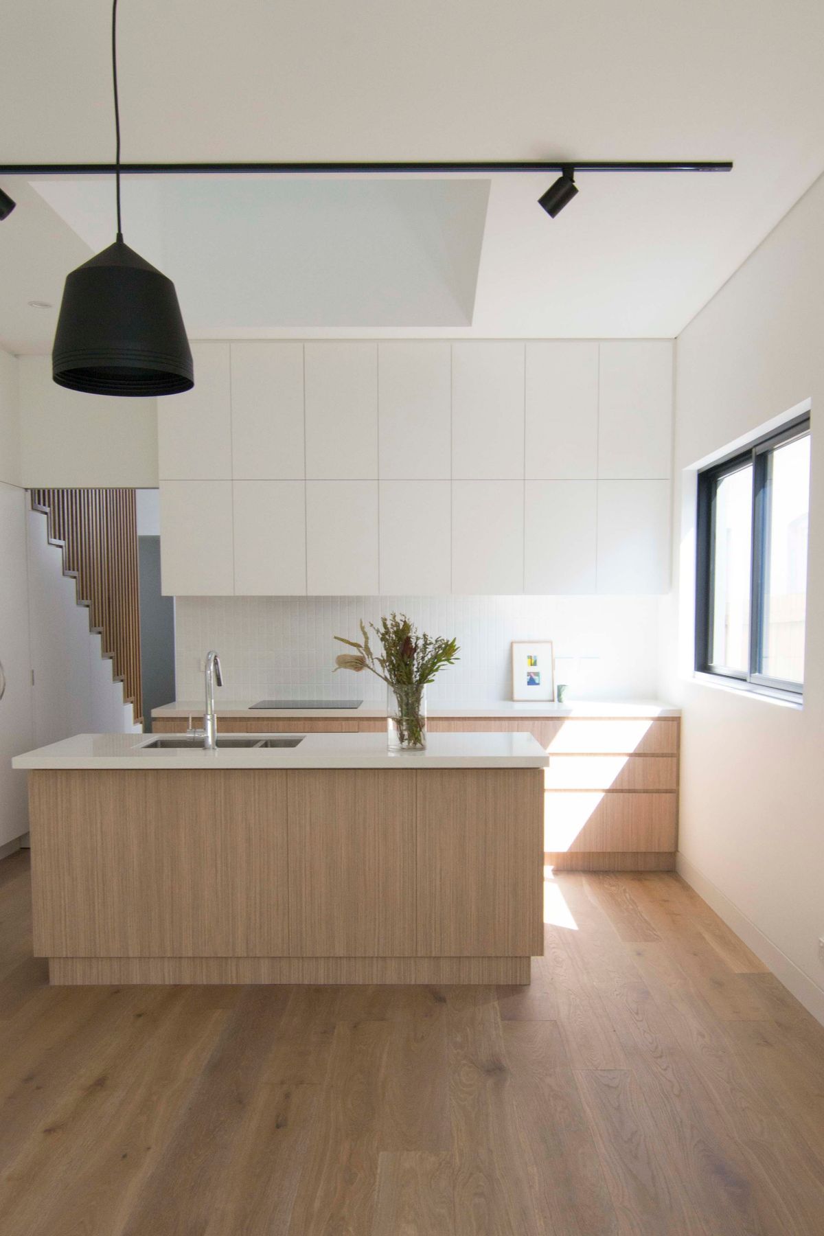 A soft and raw material palette for the kitchen. A consideration for natural light and view points as a void over connects the two levels.