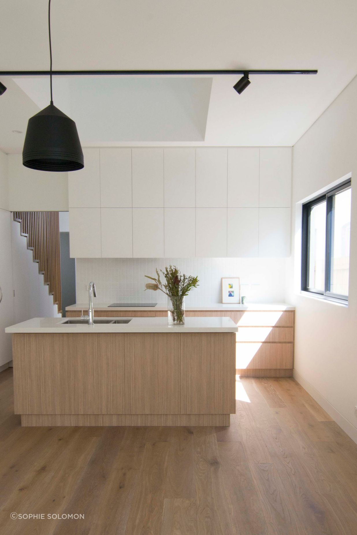 A soft and raw material palette for the kitchen. A consideration for natural light and view points as a void over connects the two levels.