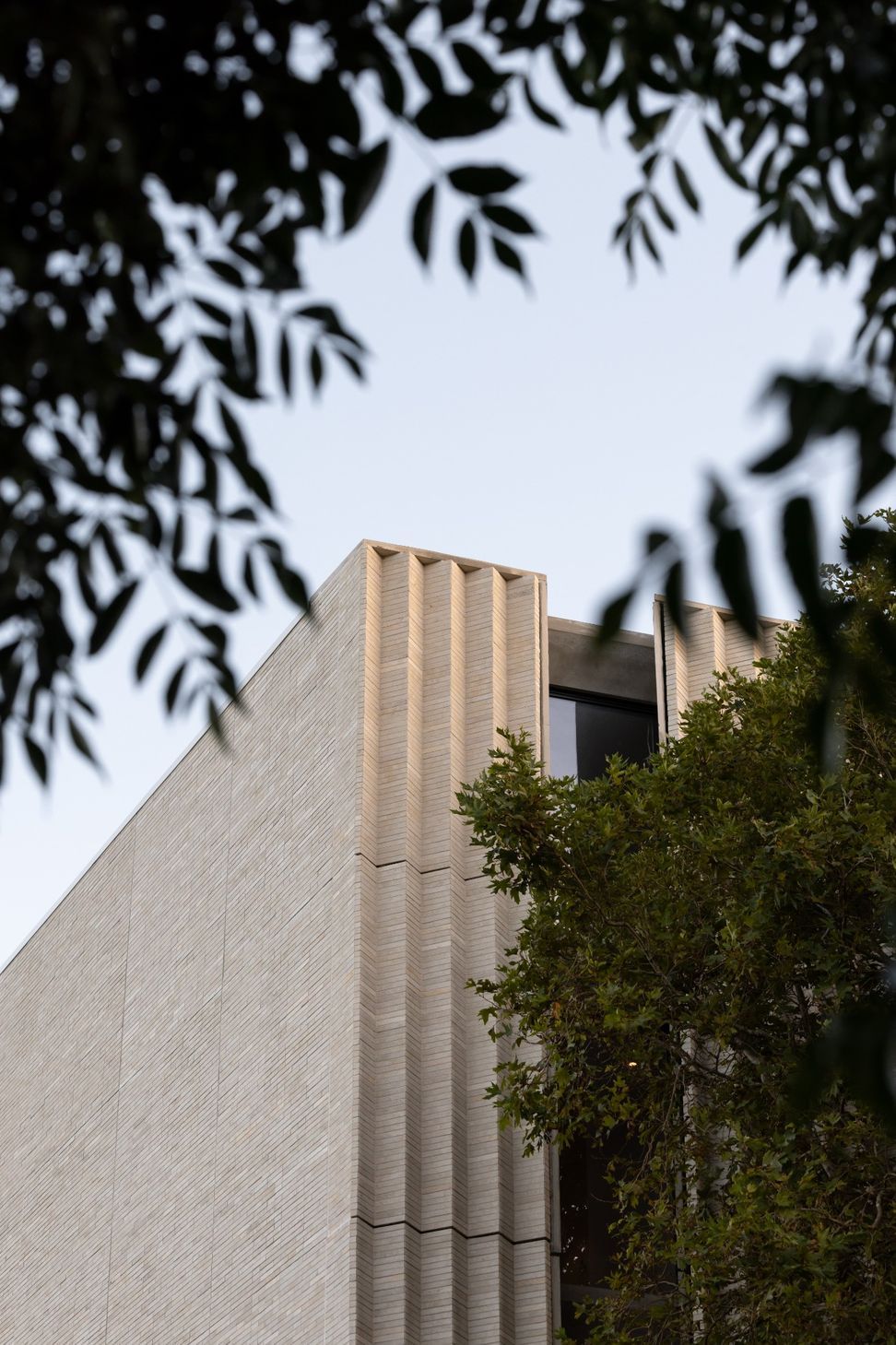 JThe-natural-limestone-facade-wraps-the-building-as-a-continuous-stone-screen-giving-the-compact-multi-residential-form-a-quiet-enduring-presence-on-Jervois-Road-Photograp-v2.jpg