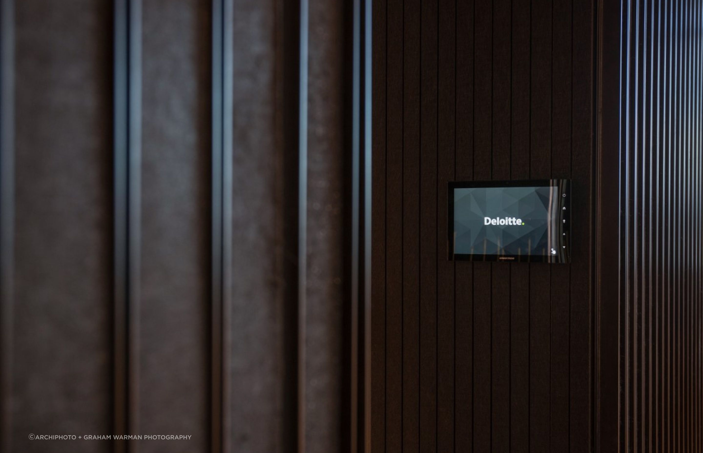 Detail - bespoke linear acoustic/steel cladding of dark wall