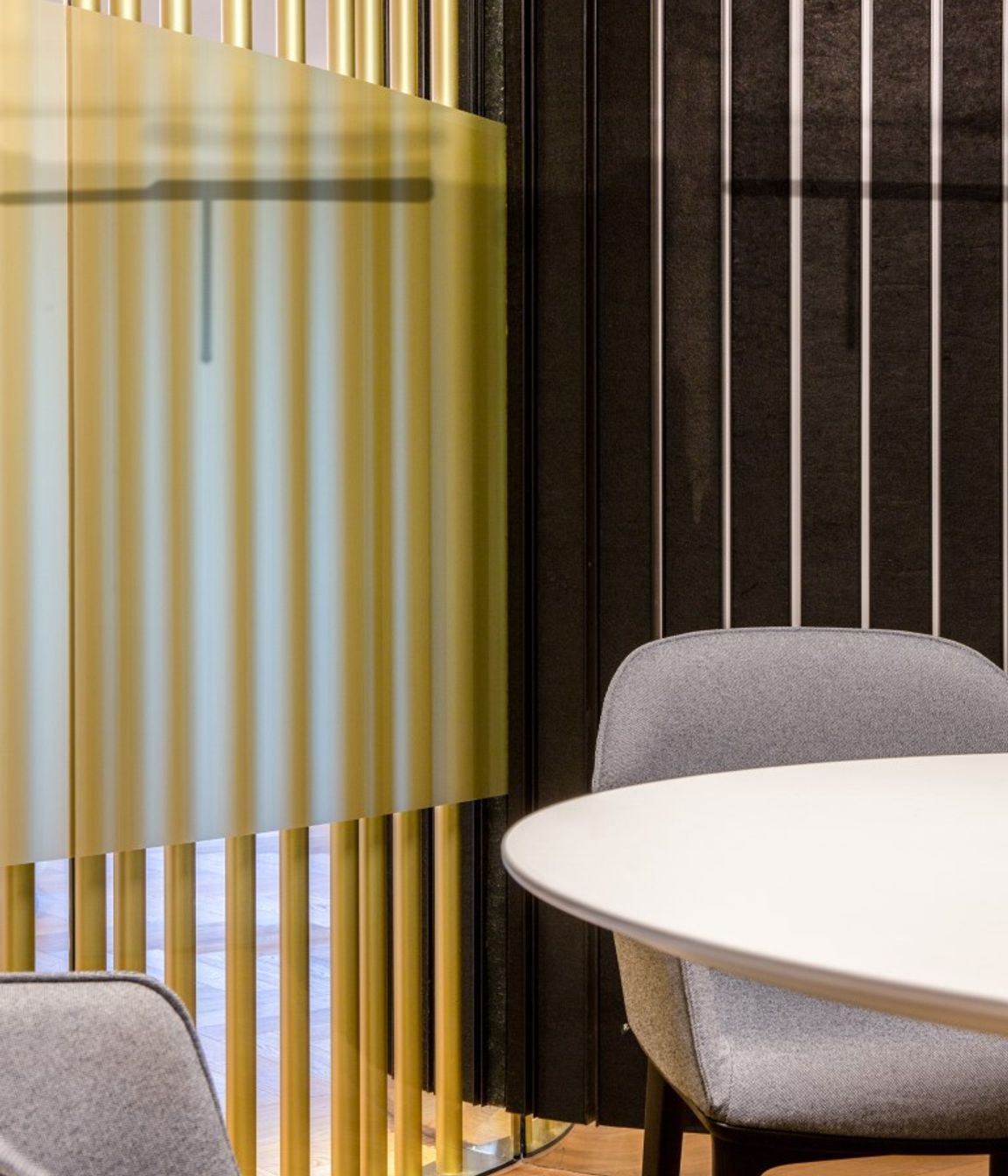 Detail - brass pole screen and acoustic dark wall