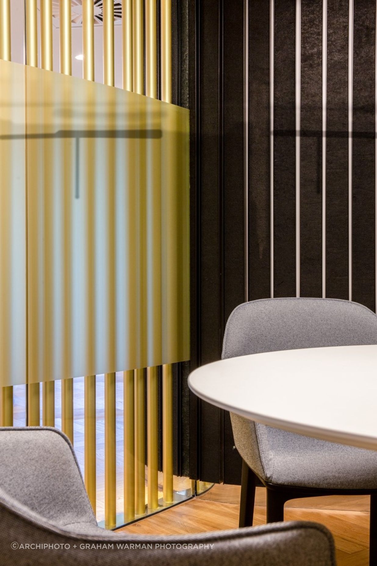 Detail - brass pole screen and acoustic dark wall