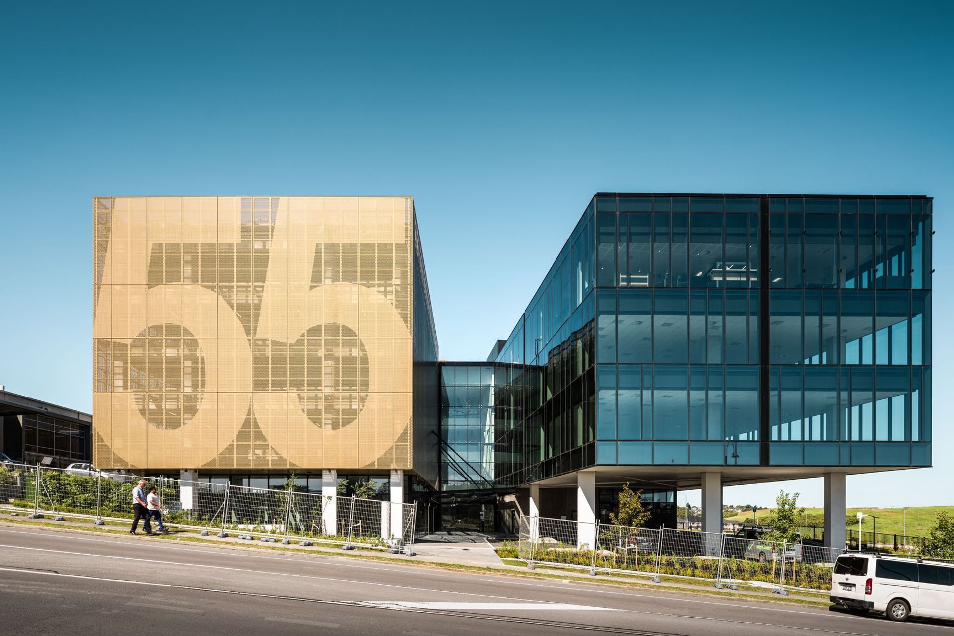 The view from Corinthian Drive showcases the number '55' on the perforated metal screens of the car parking building.