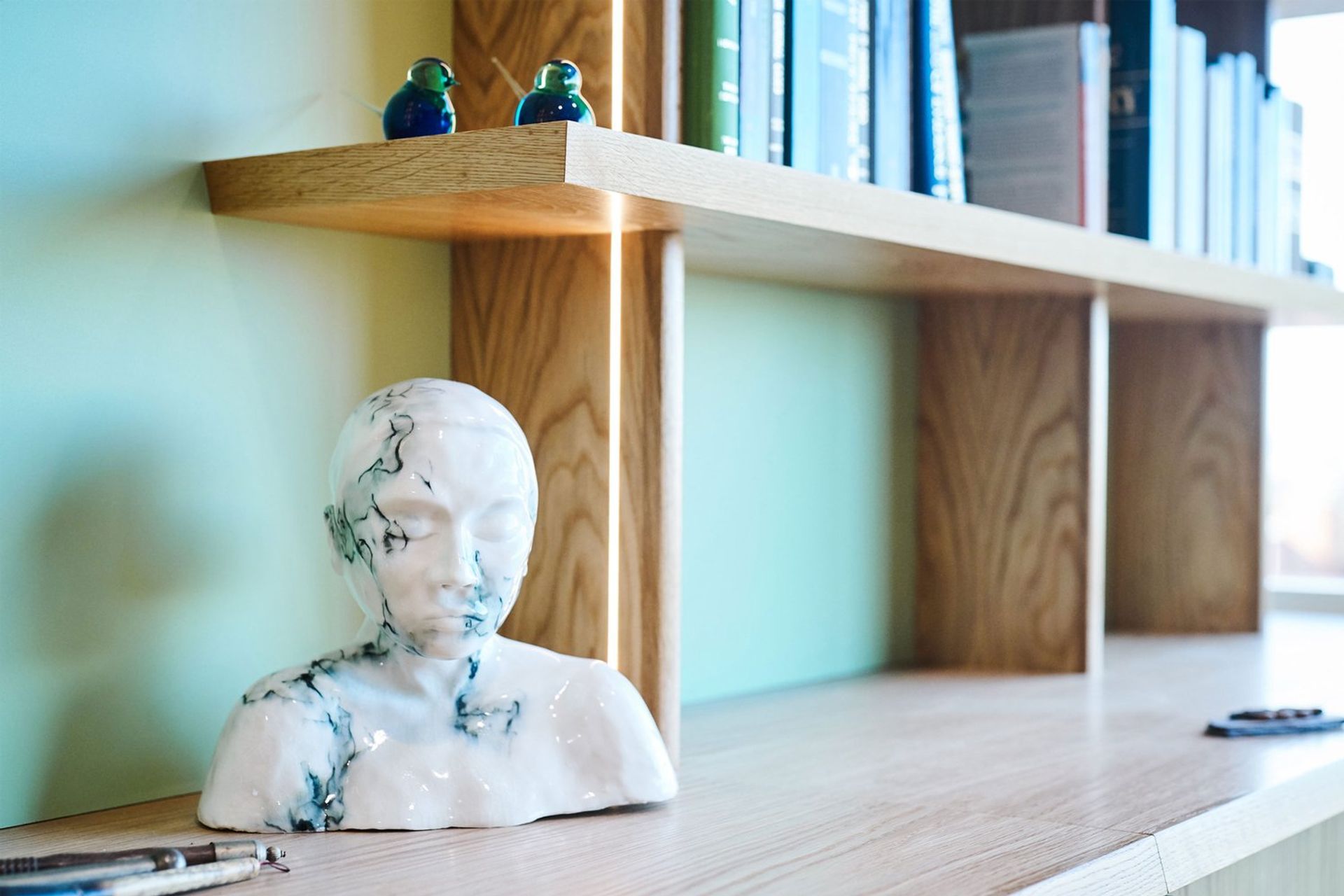 The shelves and credenza top feature a chamfered solid timber edge at opposing angles.
