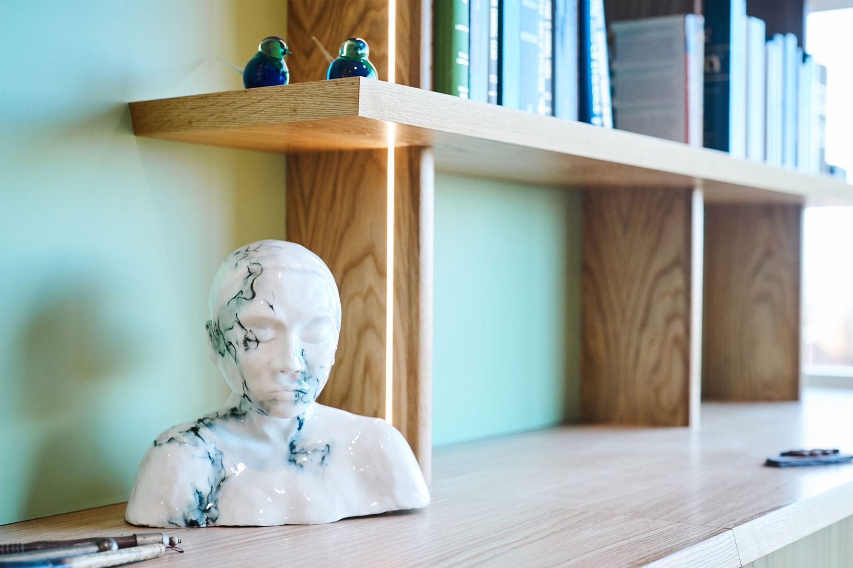 The shelves and credenza top feature a chamfered solid timber edge at opposing angles.