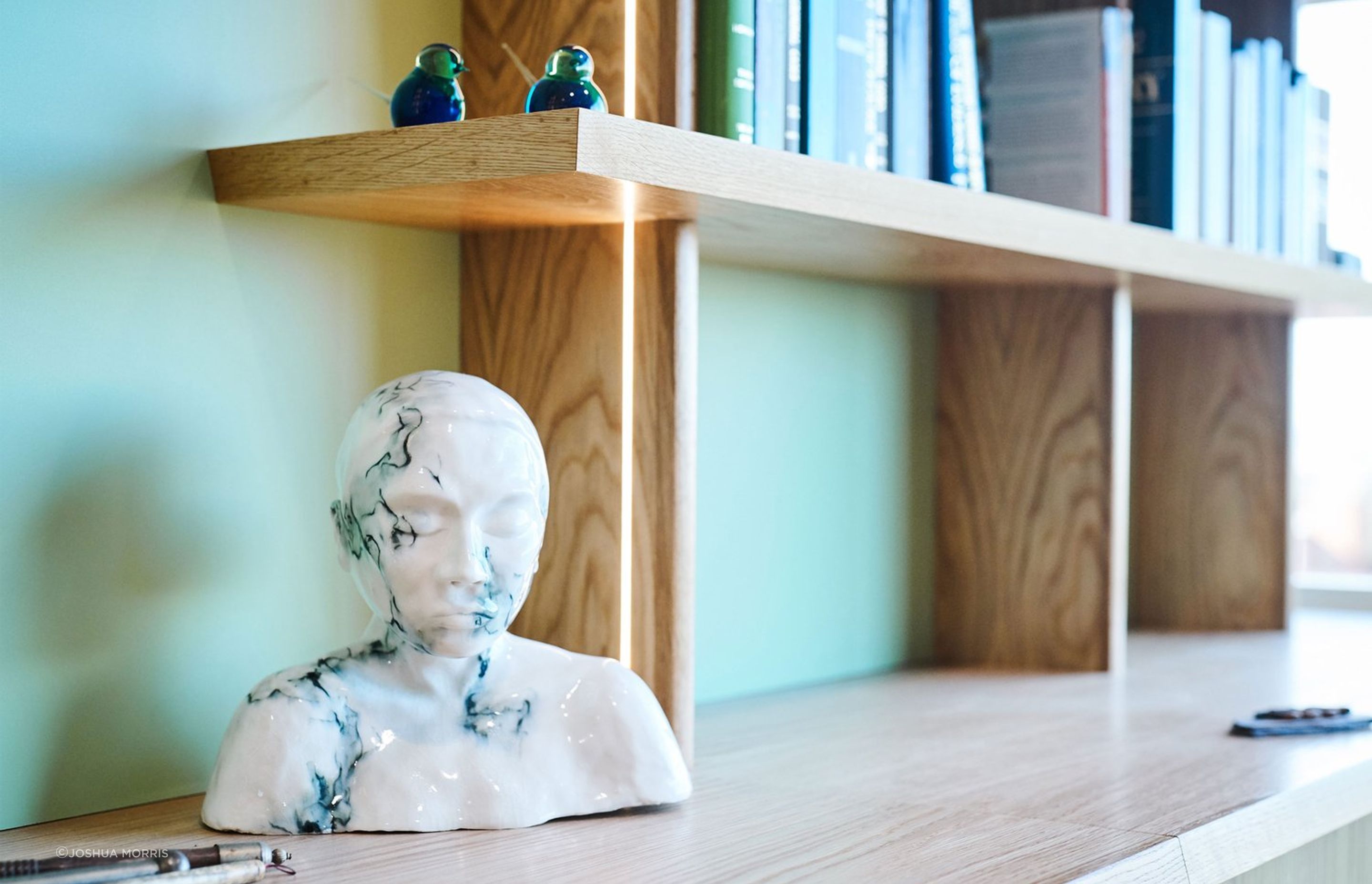 The shelves and credenza top feature a chamfered solid timber edge at opposing angles.