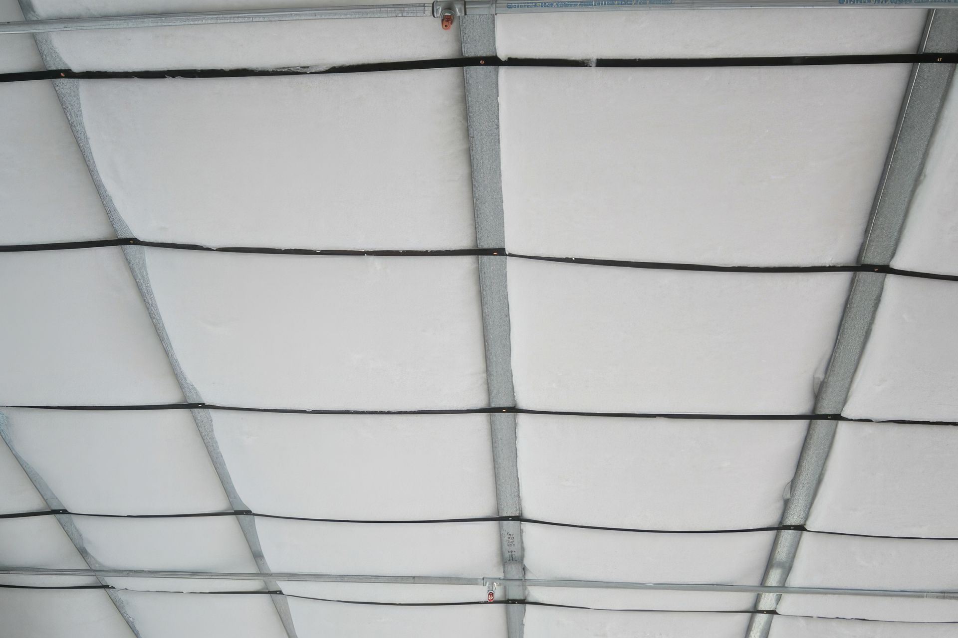 Polyester ceiling insulation installed pre-lining in the Quad 5 offices.
