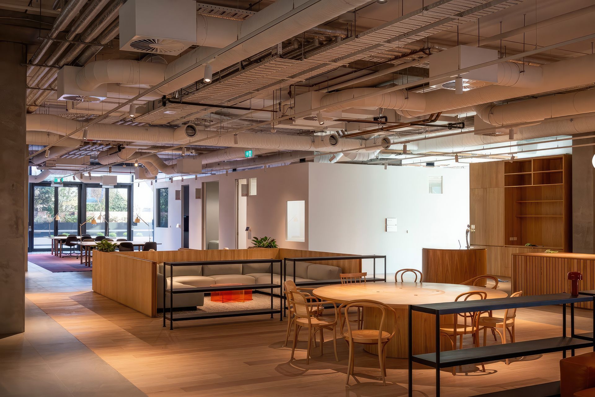 The industrial feel of the space is established by the exposed ceiling seen here on the ground floor.