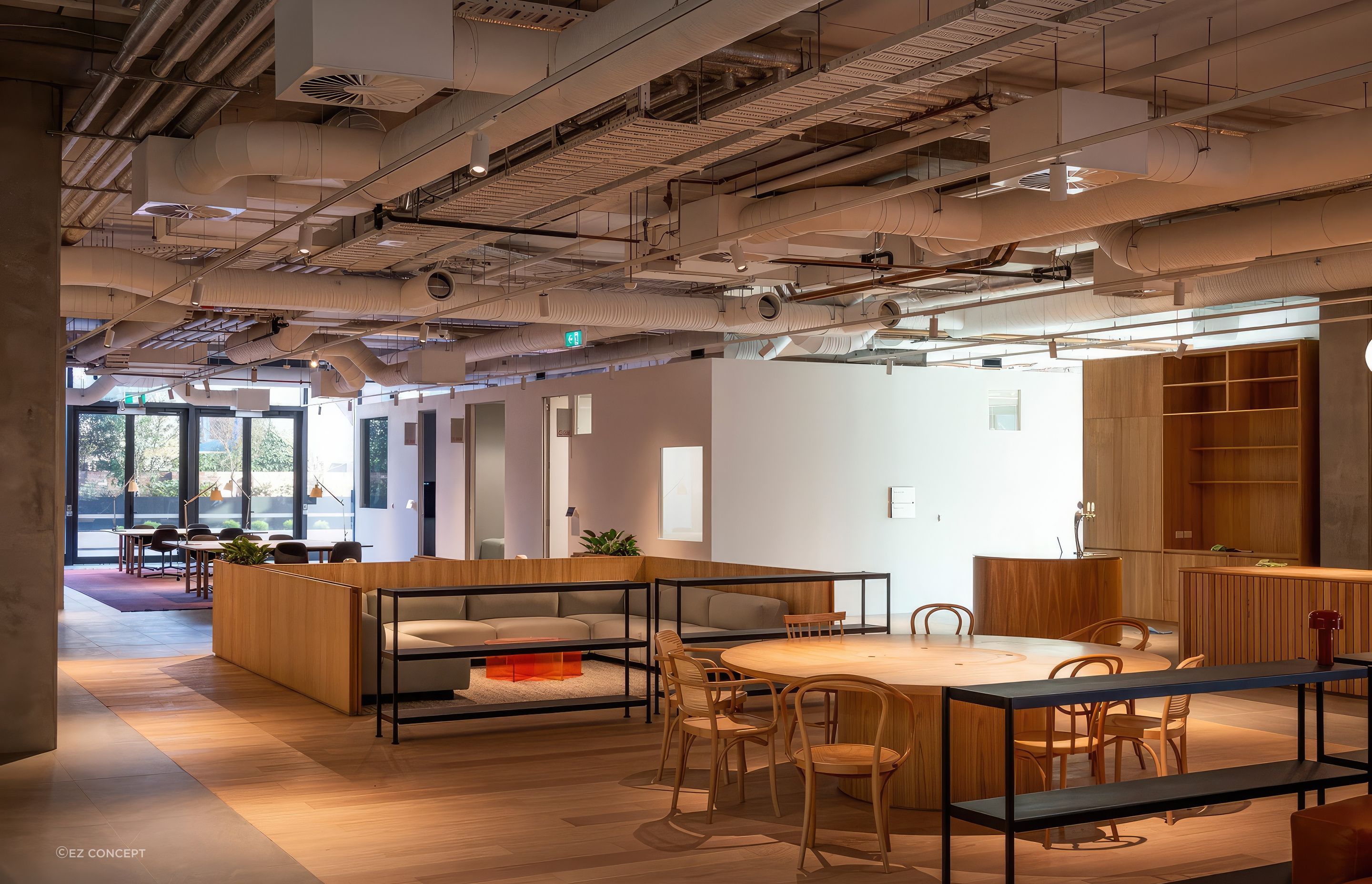 The industrial feel of the space is established by the exposed ceiling seen here on the ground floor.
