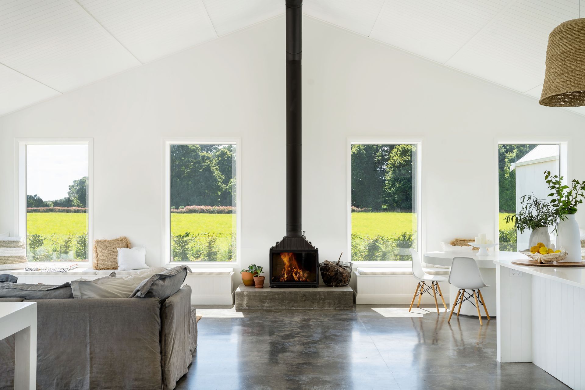 The French Cheminees Philippe cast-iron fireplace contrasts against the white interior to create a focal point in the home