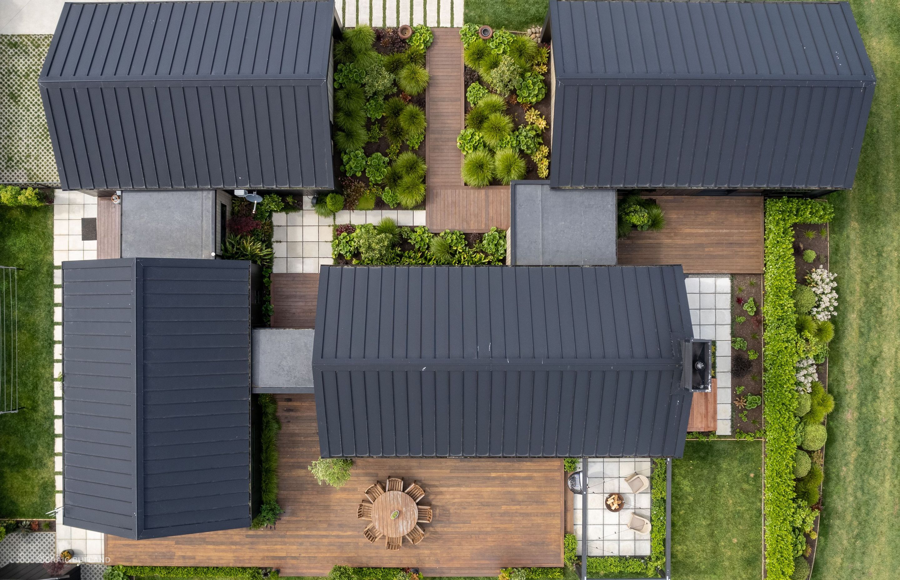 The modular layout creates several options for sheltered courtyards on all sides of the house connected by glazed walkways, bringing the outdoors in.