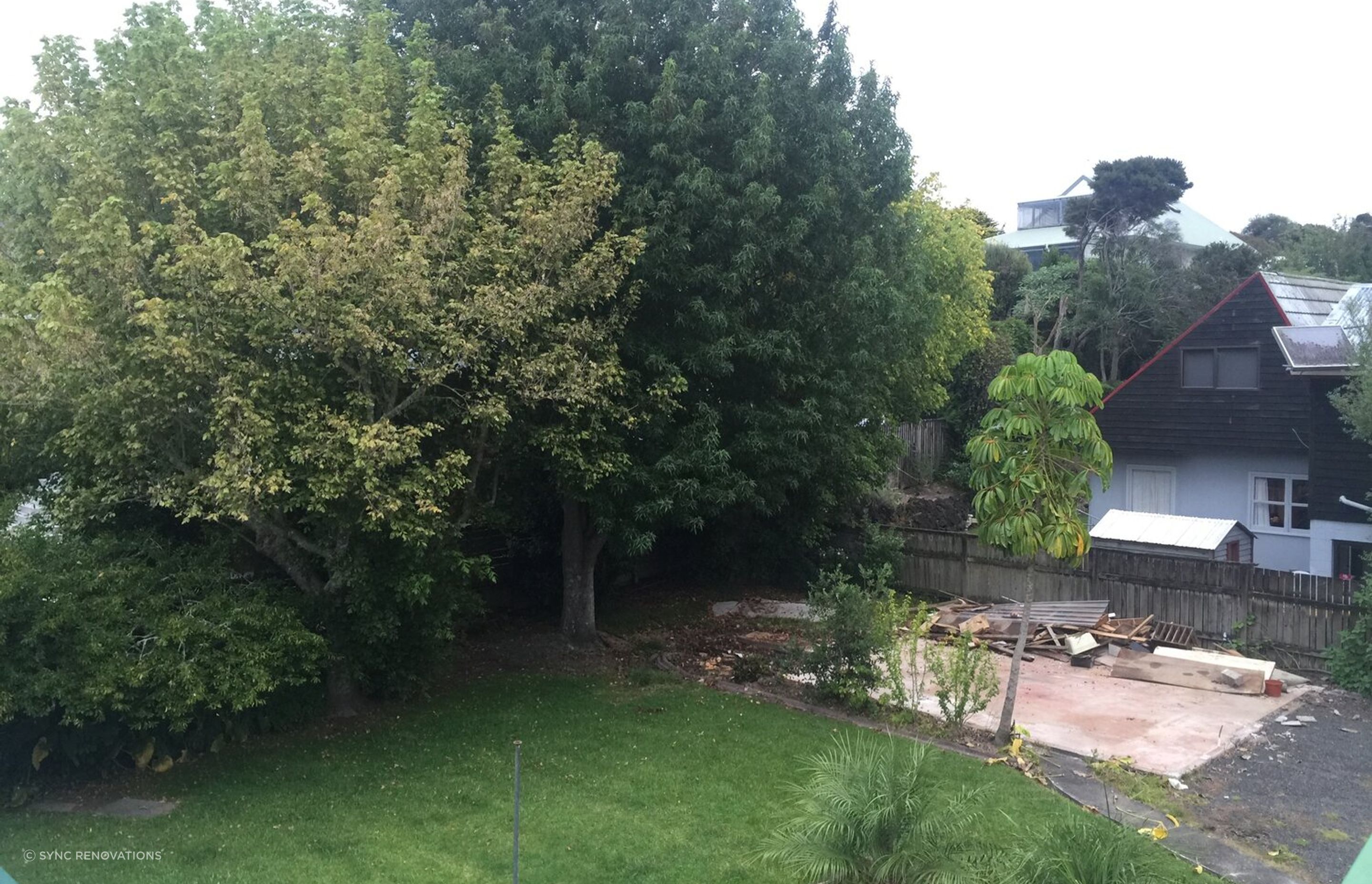 The existing garage was transported from site to a new location, and the trees were removed to make space for the new house.