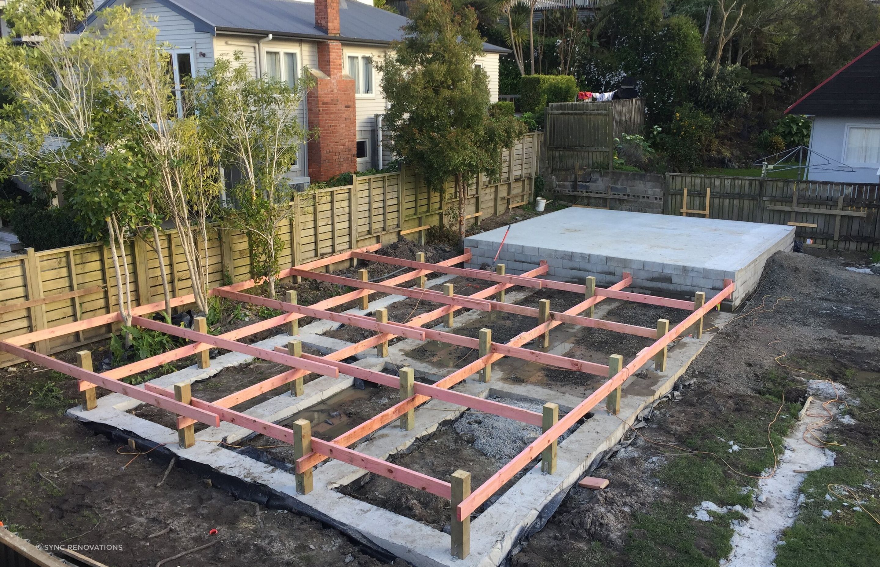 Concrete poured for the floating piles, and initial flooring framework going up.