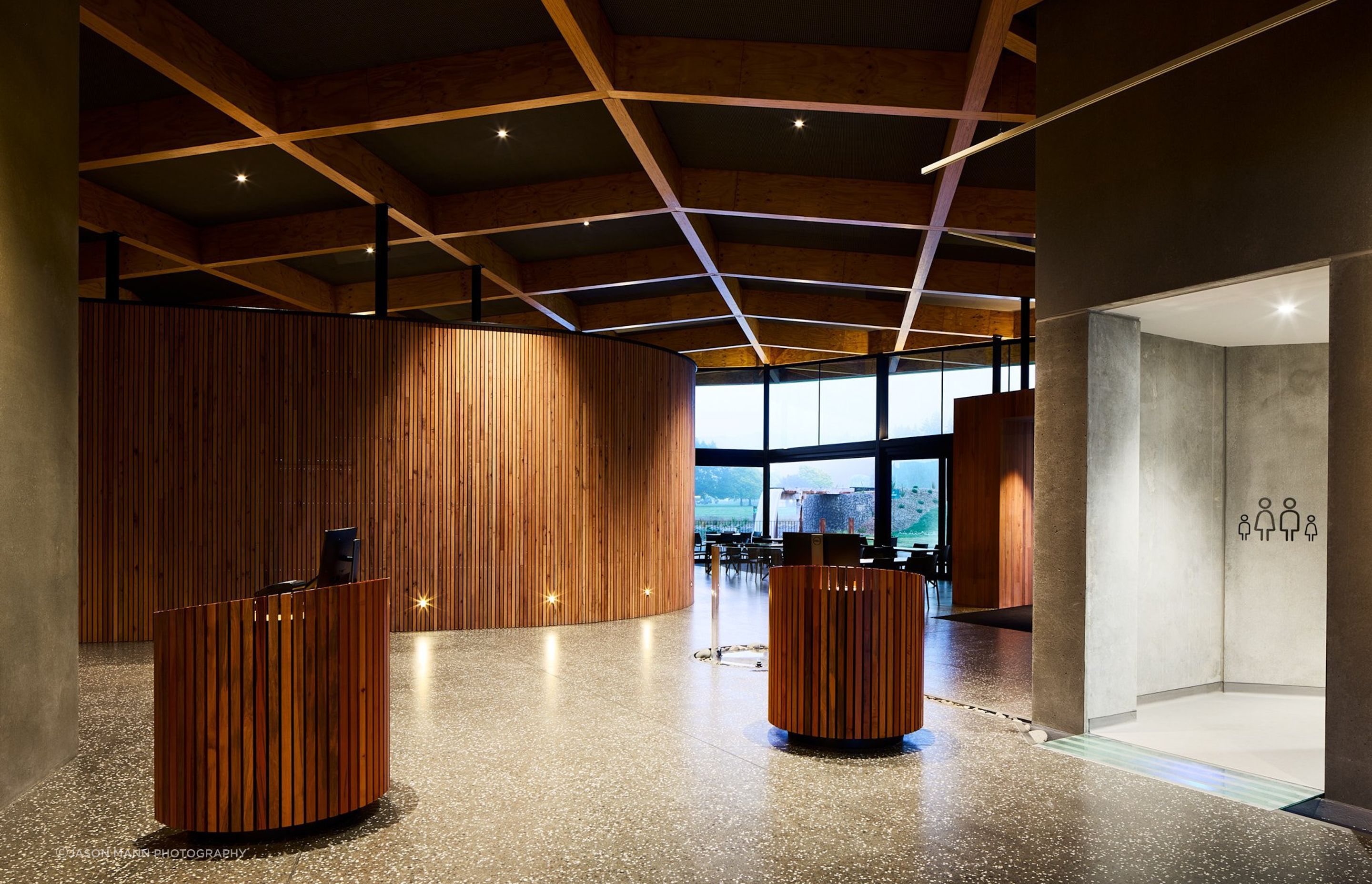 The concrete floor of the interior is composed of local aggregate, and leads you on a winding journey through the change rooms out to the pool.